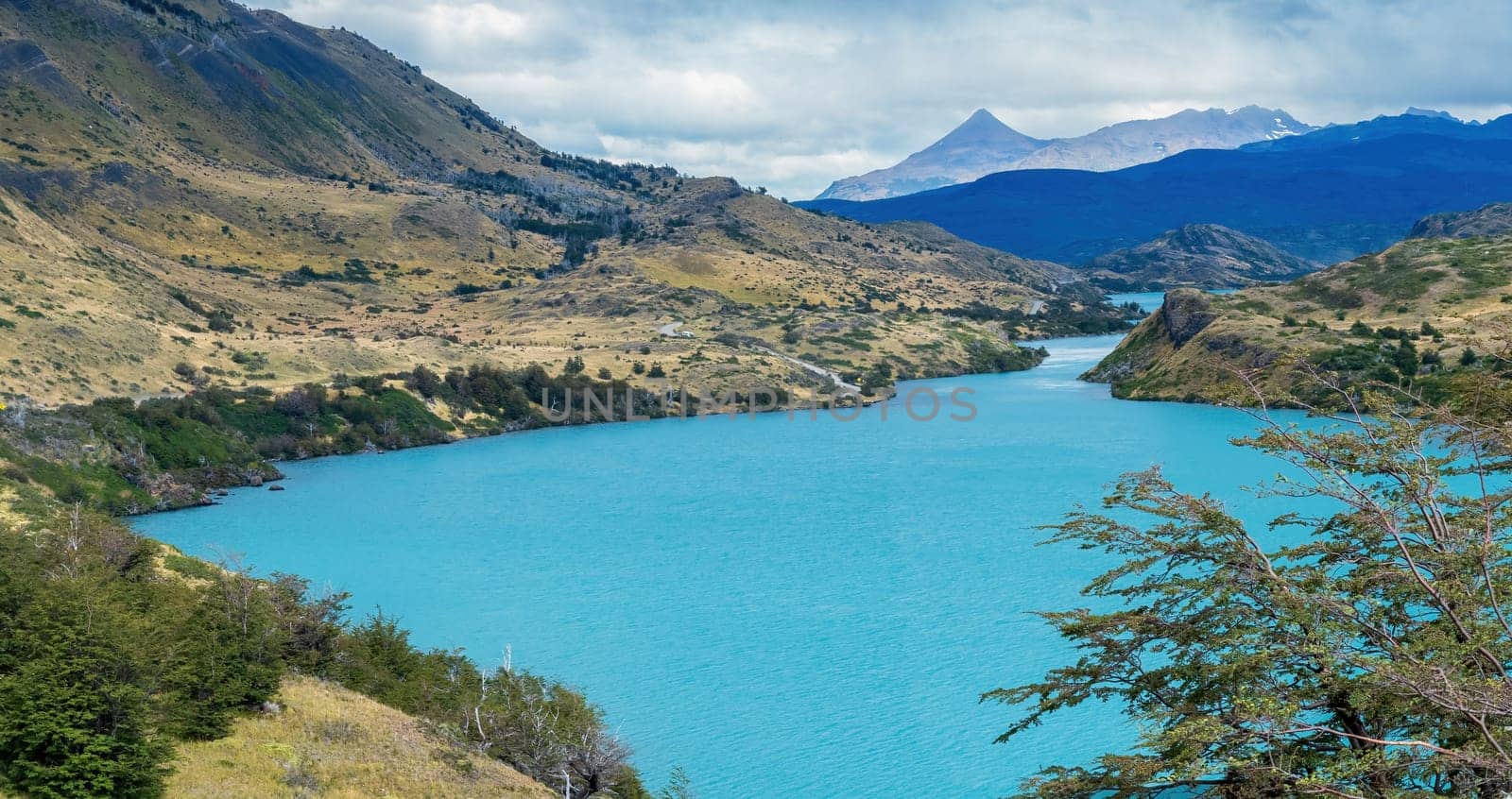 Secluded turquoise lake surrounded by mountains offering a tranquil setting.