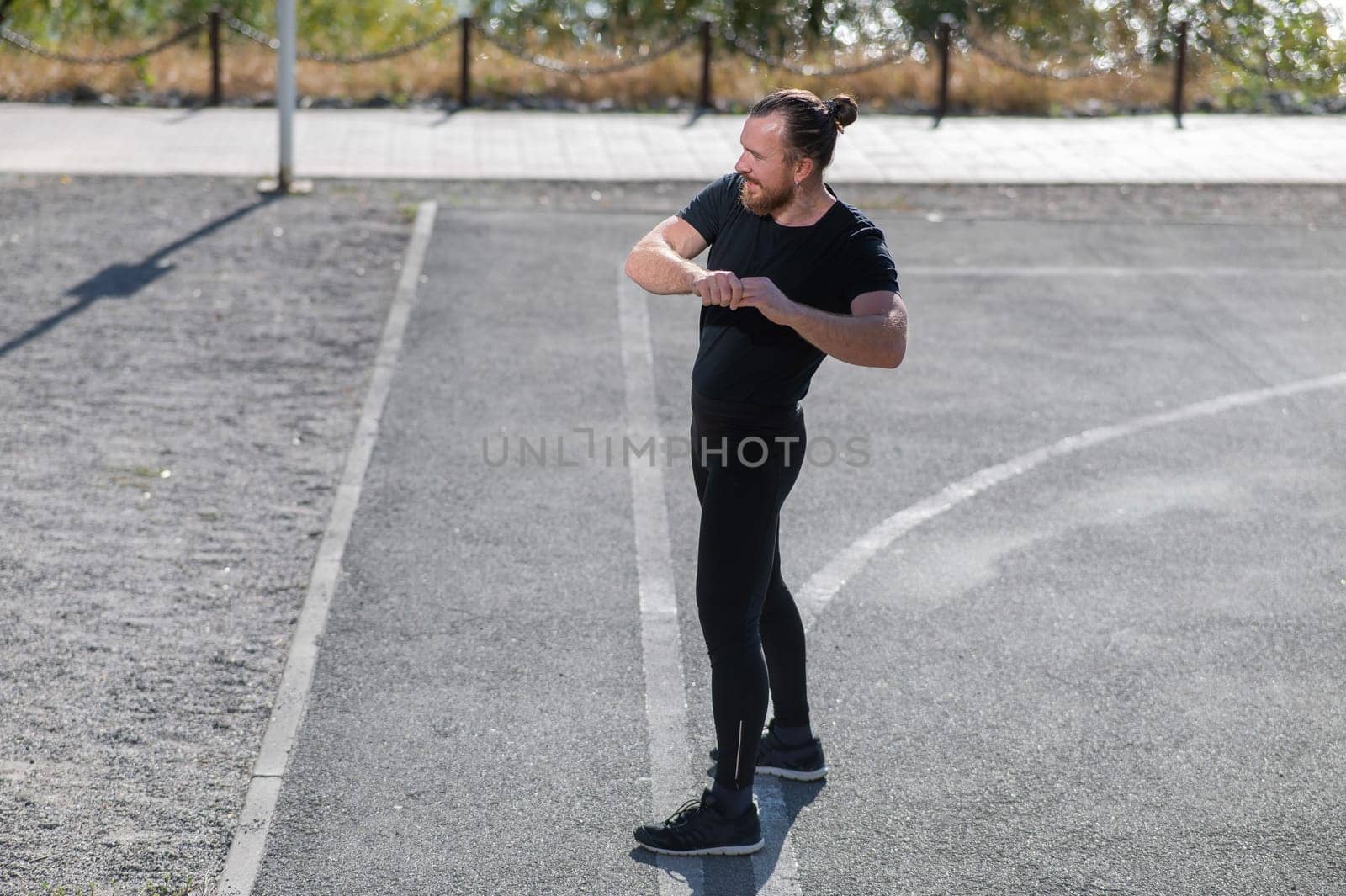 Bearded man doing exercises outdoors