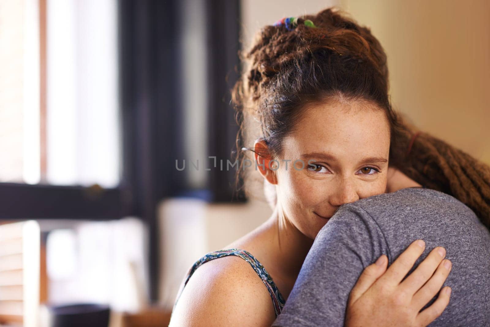 Portrait, couple and hug for love or commitment with romance for relationship, affection and connection for dating anniversary. Female person and man in home together for bonding, security and care