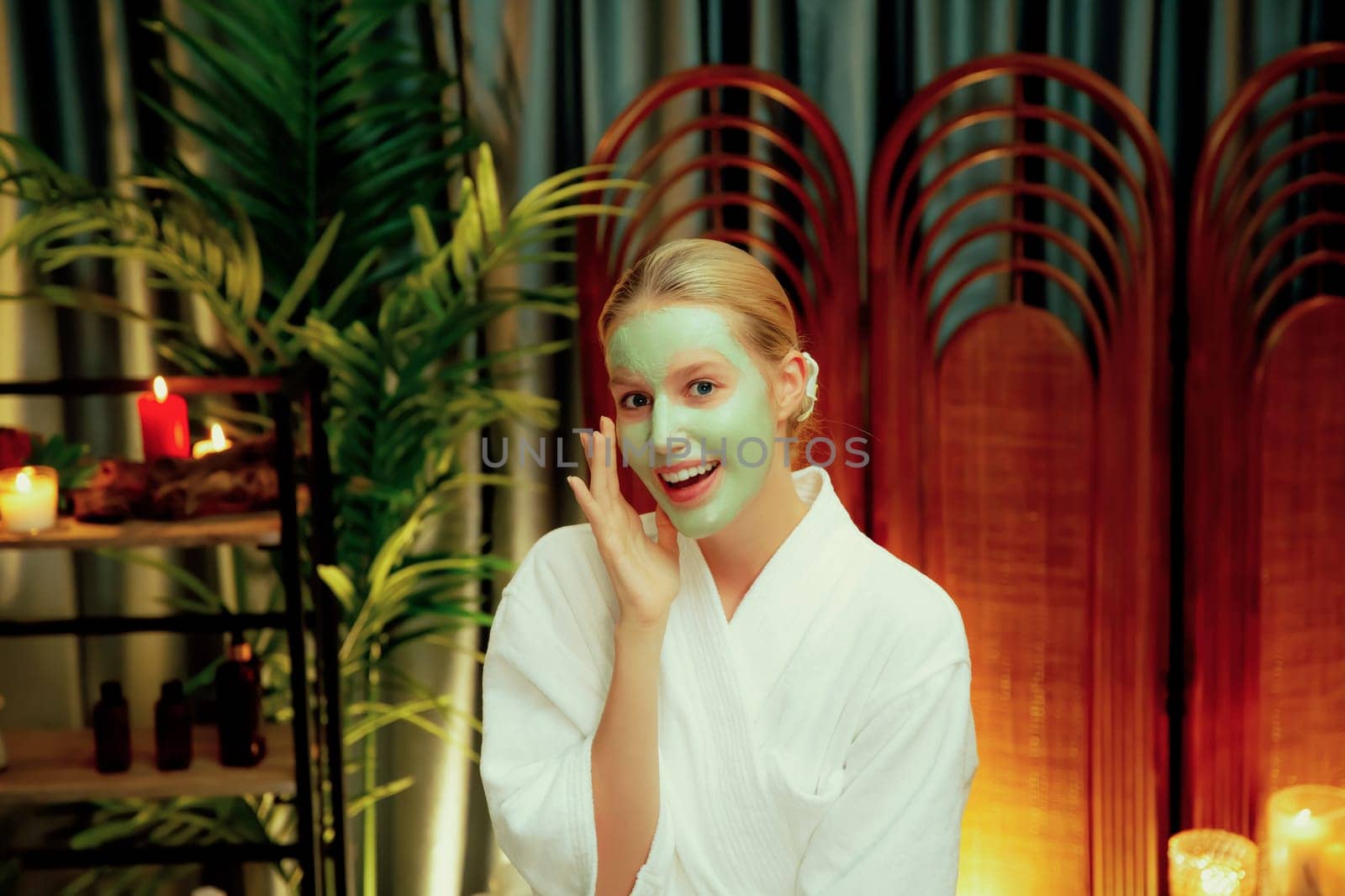 Woman indulges in rejuvenating with luxurious face cream spa massage. Quiescent by biancoblue