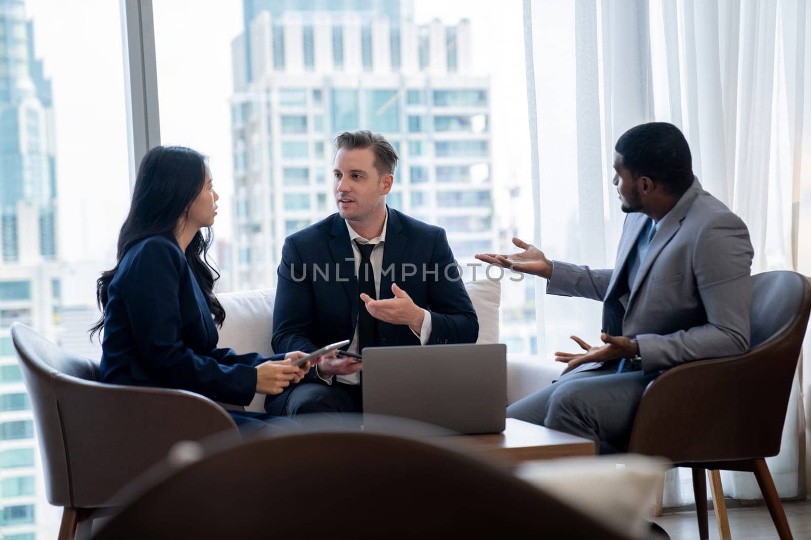 Young smart businesswoman showing data analysis to diverse investor by using tablet. Multicultural business group discussing and investing in start up project. Modern office. Meeting. Ornamented.