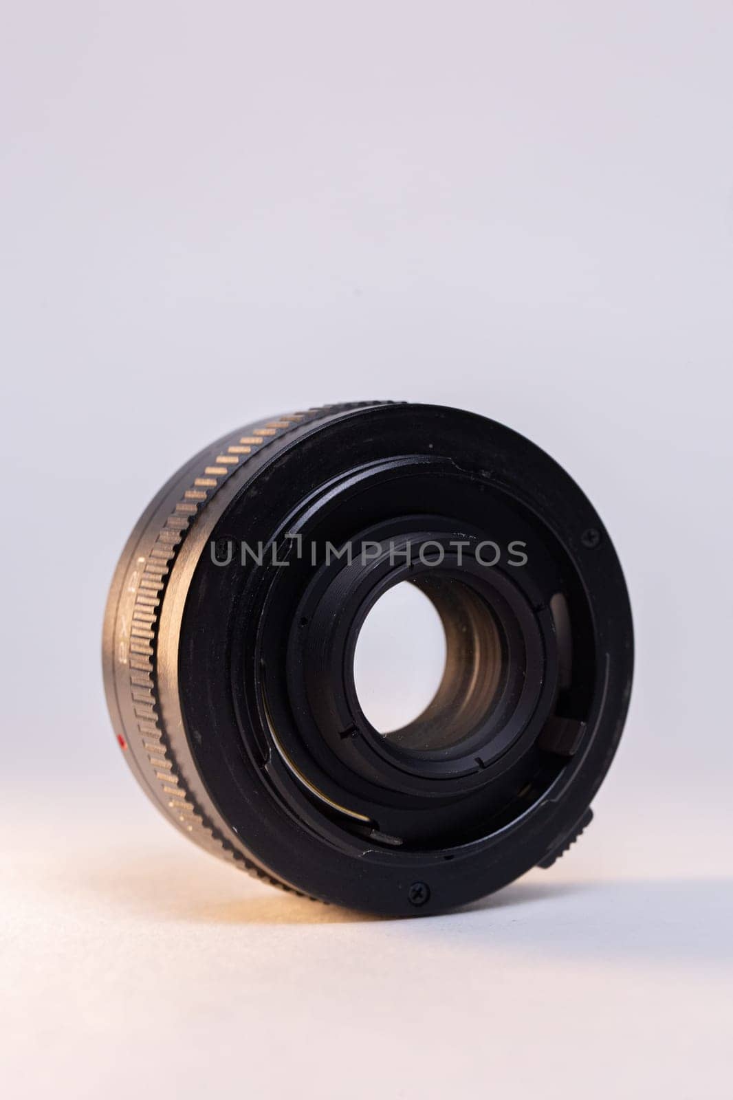 Black camera telephoto lens converter on white background by Pukhovskiy