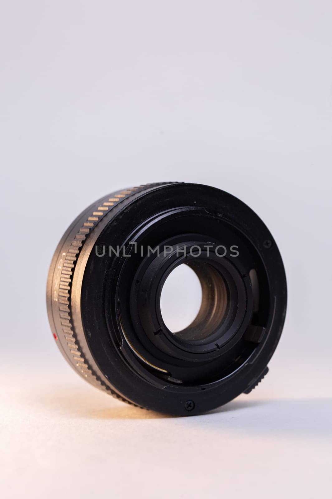 A black camera telephoto lens converter on a white background, perfect for photography enthusiasts and professionals.