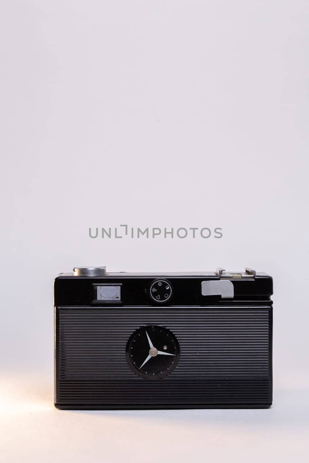 Retro camera with a silver body on a white background by Pukhovskiy