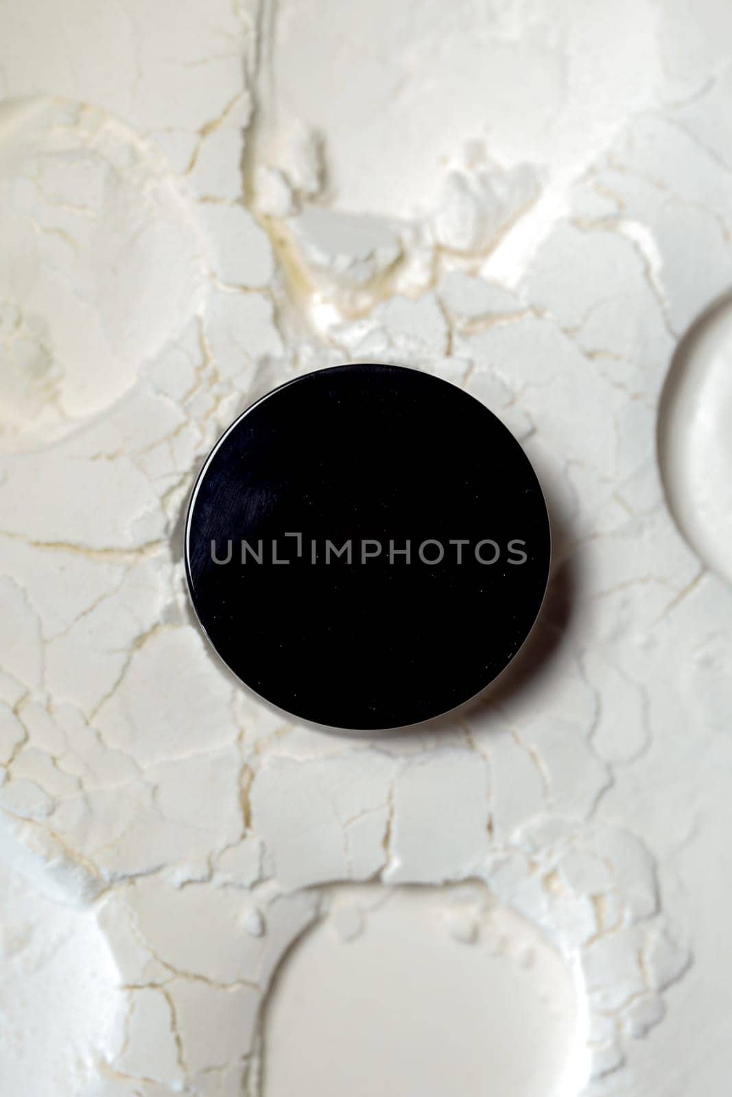 Black round podium on white powder background. Isolated on white. by Pukhovskiy