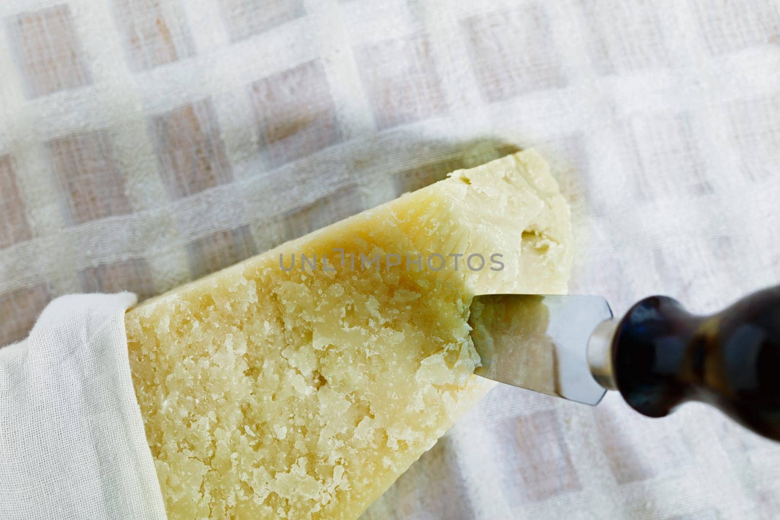 Parmesan cheese with knife by victimewalker