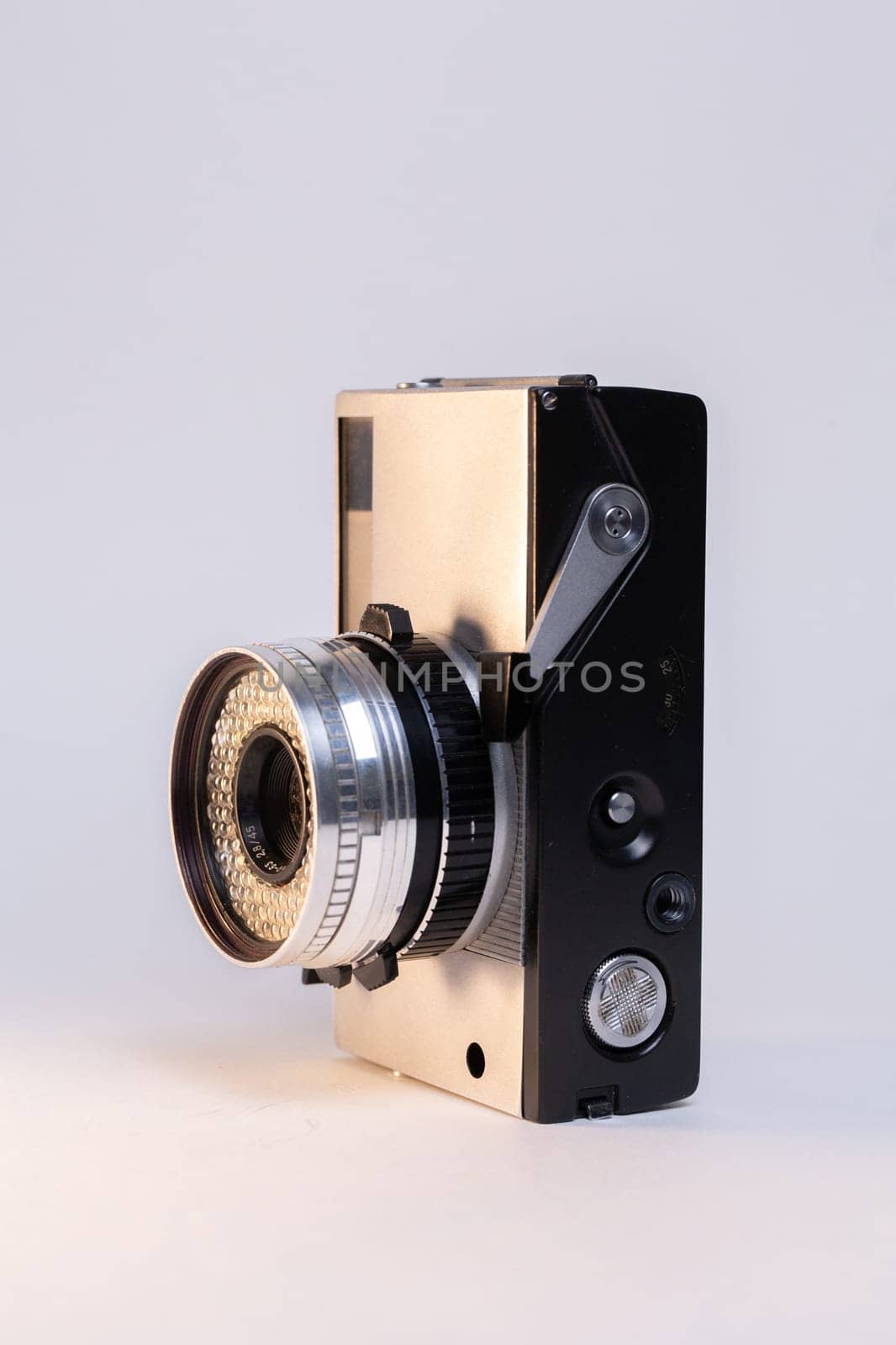 Retro camera with a silver body on a white background by Pukhovskiy