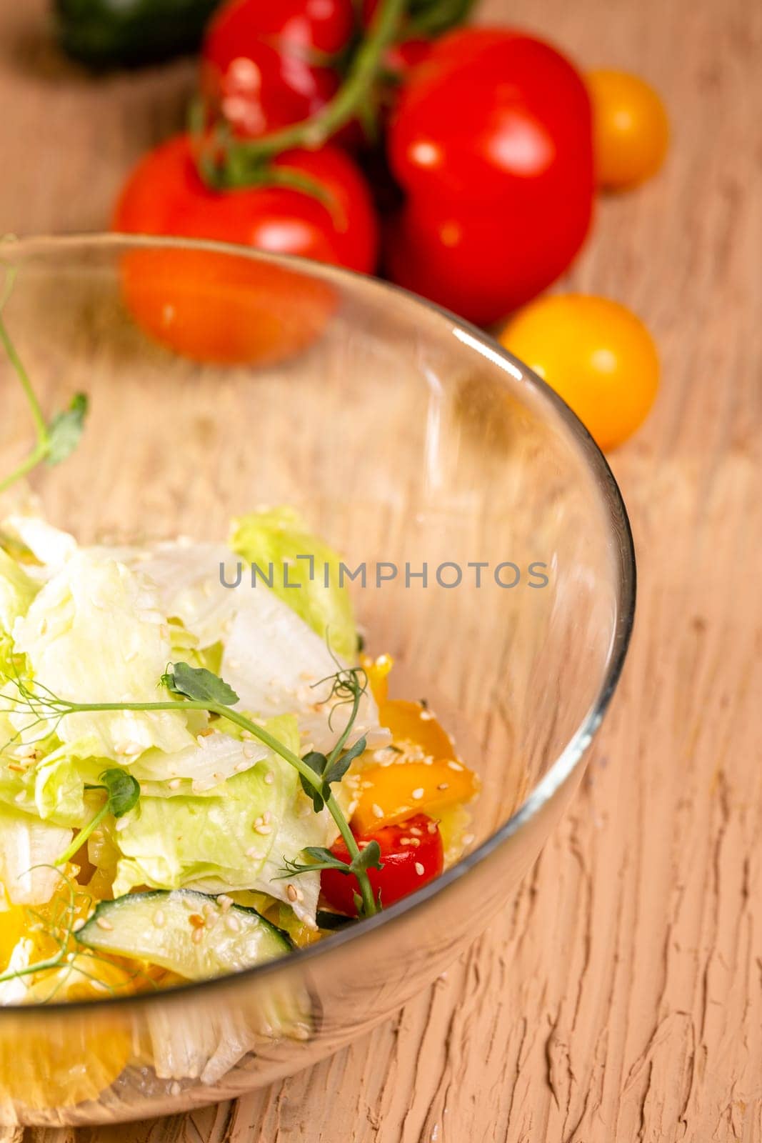 Delicious salad with organic vegetables, cherry tomatoes, cucumbers, lettuce, cabbage and greens. Healthy food concept