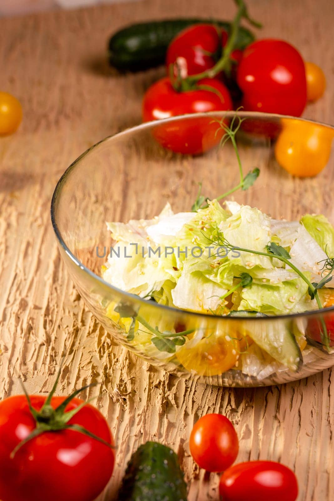 Delicious salad with organic vegetables, cherry tomatoes, cucumbers, lettuce, cabbage and greens. Healthy food concept