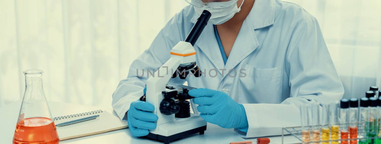 Laboratory researcher develop new medicine or cure using microscope. Rigid by biancoblue