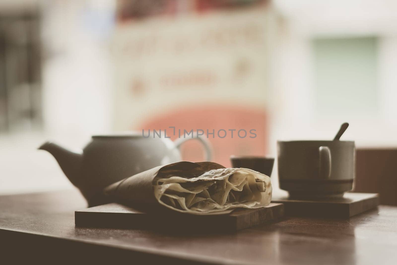Mental warmth comfort calm silence. Breakfast cafe. Vintage matte photo. Ceramic kettle mug, large pancake on wooden board.