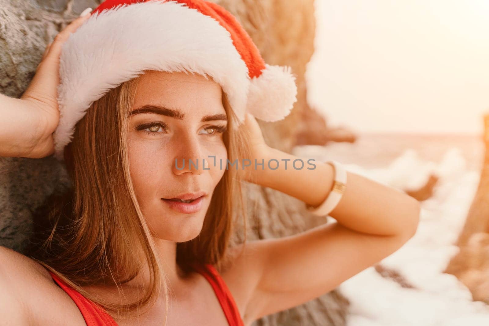 Woman travel sea. Young Happy woman in a long red dress posing on a beach near the sea on background of volcanic rocks, like in Iceland, sharing travel adventure journey