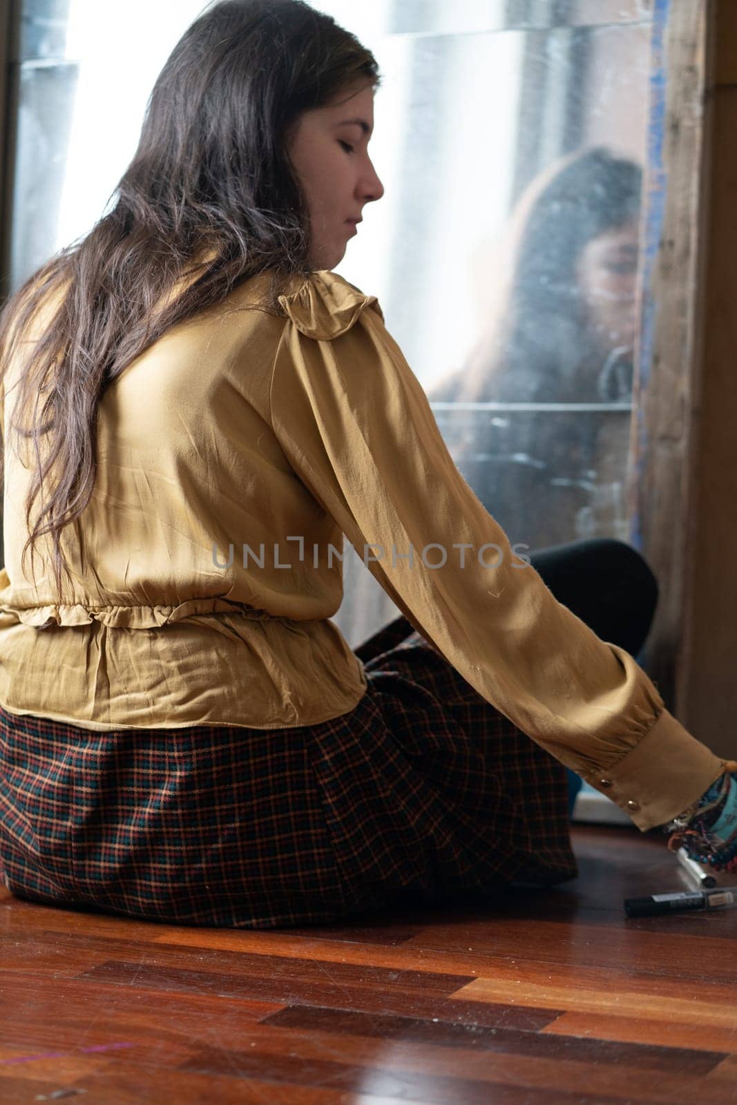 young beautiful woman applying makeup near the mirror