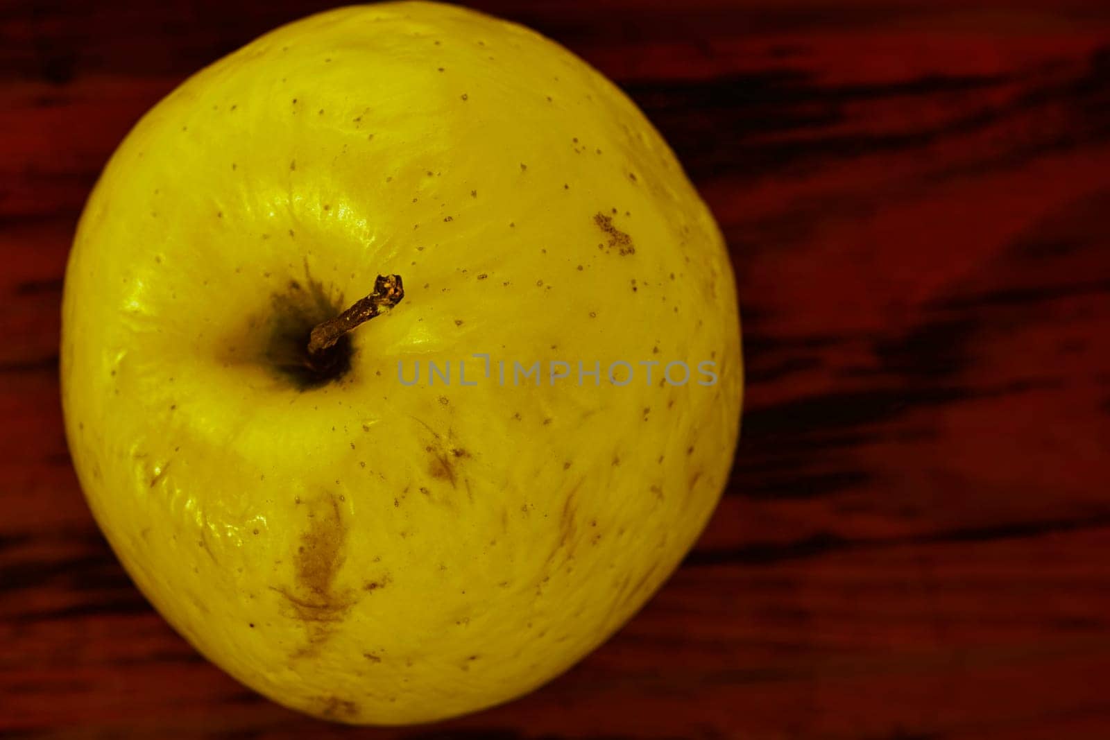 Yellow apple on colored background by victimewalker