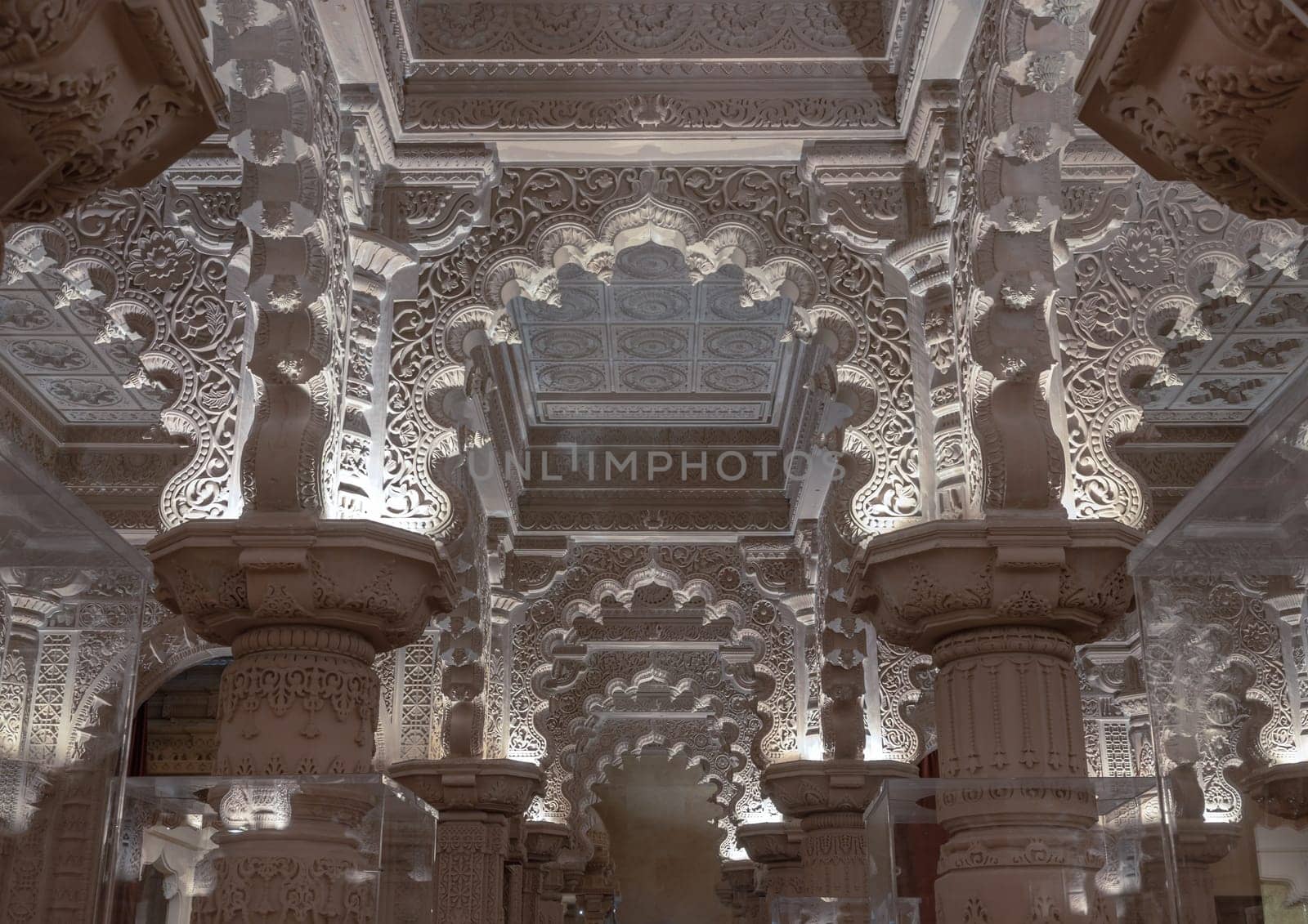 London, UK - Feb 27, 2024 - The Shree Sanatan Hindu Mandir Hindu temple interior architecture with view of intricately carved stone and columns with beautiful artwork. Inside the Shri Sanatan Hindu Temple, Space for text, Selective focus.