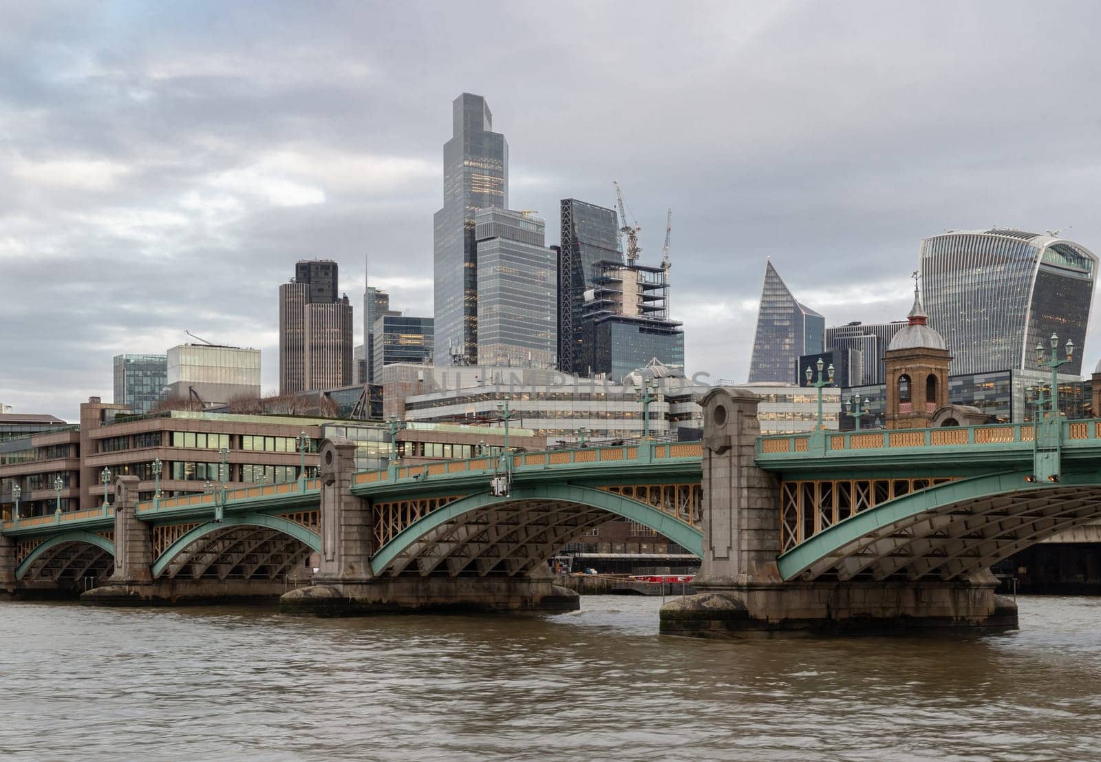 London, UK - Feb 27, 2024 - Beautiful view of Skyscrapers and Southwark bridge in the business district over River thames in city of london. Architectural modern buildings, Space for text, Selective Focus.