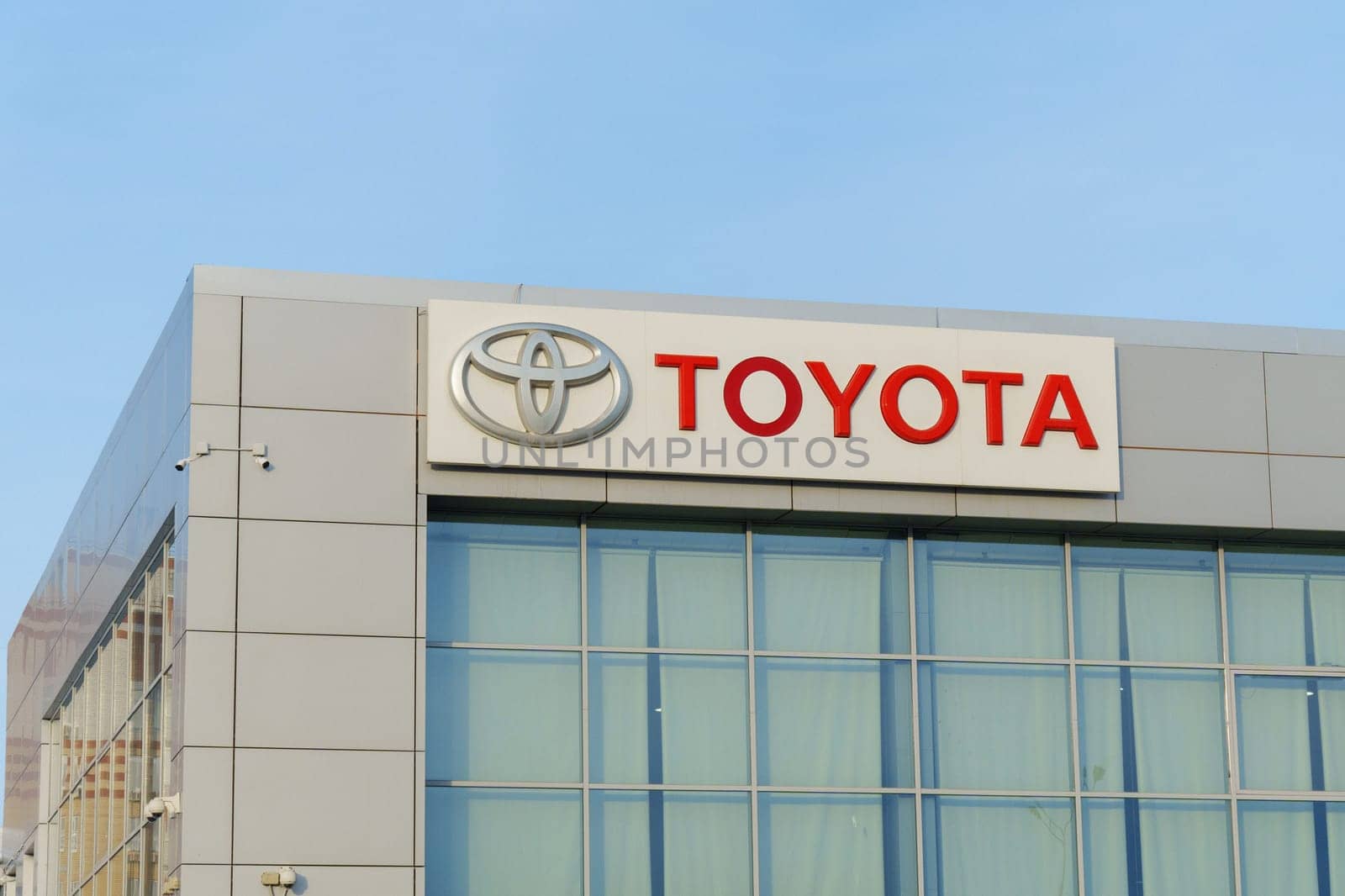 Tyumen, Russia-March 02, 2024: Toyota brand logo sign prominently displayed on the side of a commercial building in a city.