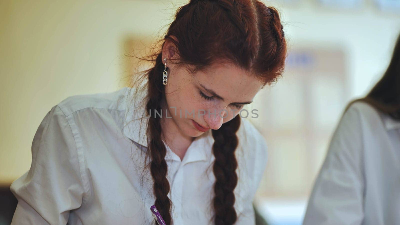 High school girls at a desk in the classroom during class