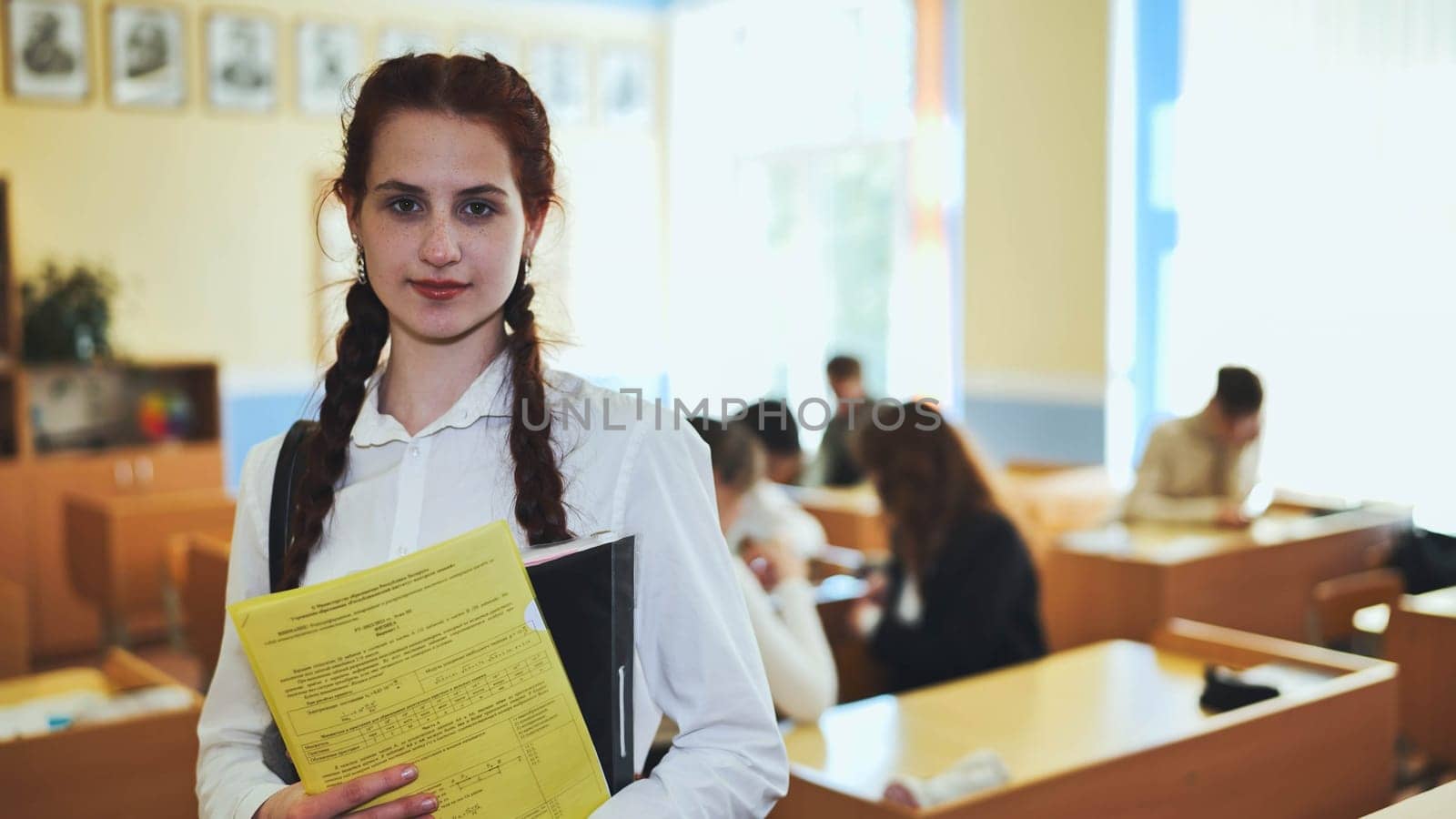 Portrait of a high school girl with notebooks. by DovidPro