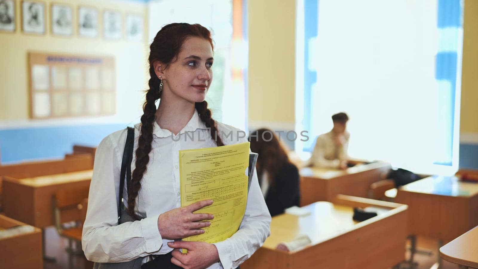 Portrait of a high school girl with notebooks. by DovidPro