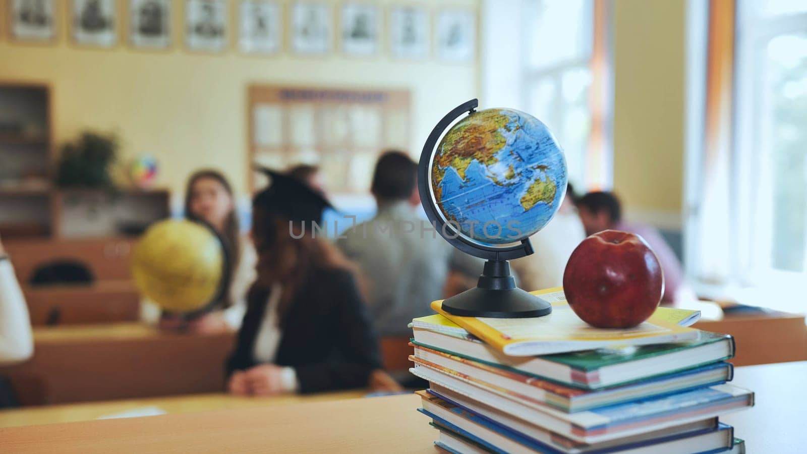 A globe of the world in a school classroom during a lesson. The globe shows Asia. by DovidPro