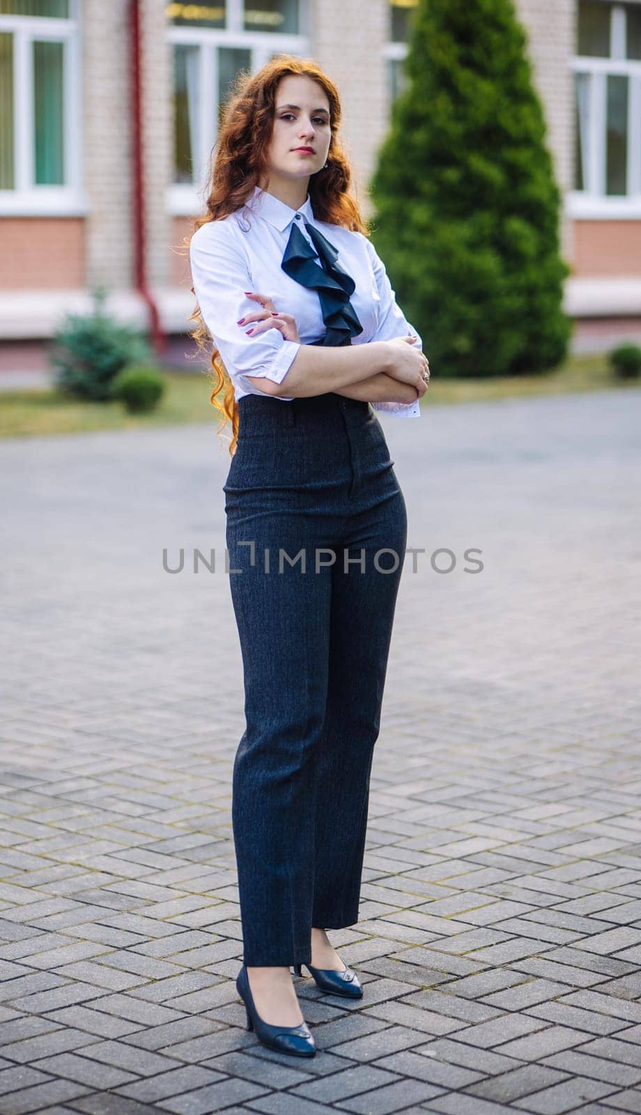 Portrait of a high school student against the backdrop of the school. by DovidPro