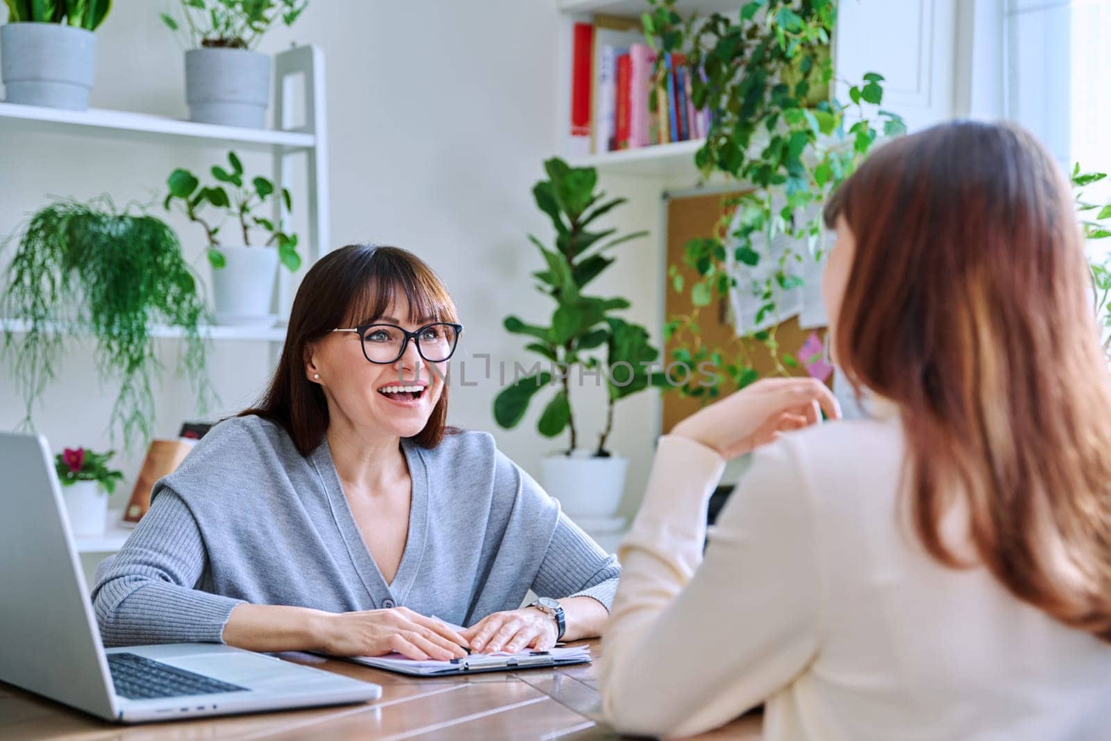 Young female college student at meeting with professional mental therapist by VH-studio