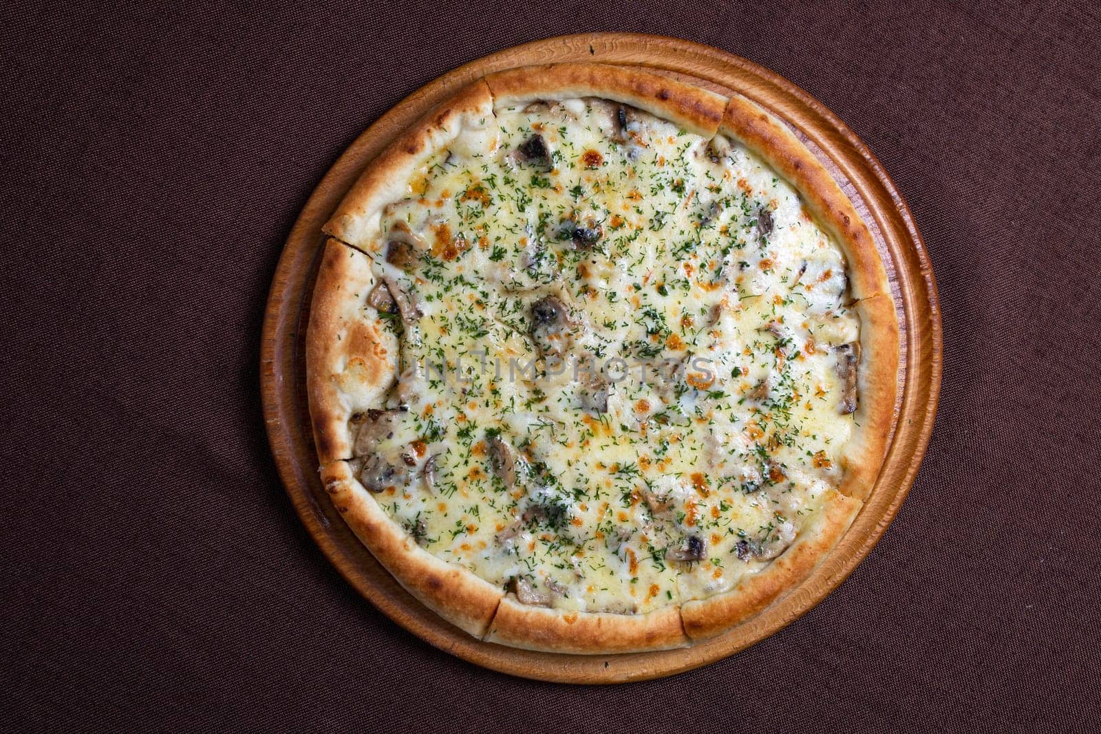 Delicious pizza with a crispy crust, topped with gooey melted cheese, flavorful mushrooms, and fragrant herbs for a satisfying meal.