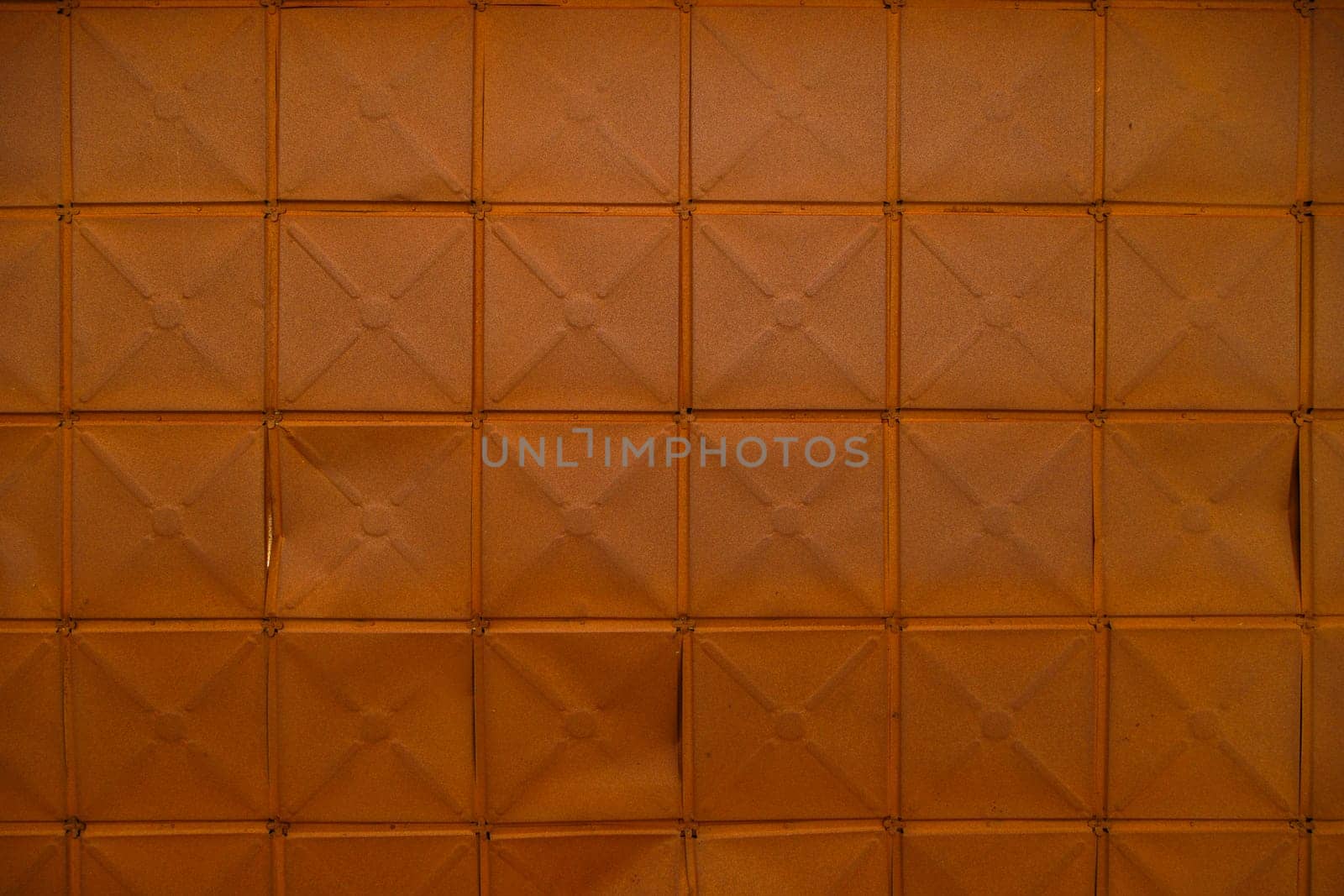 full-frame background and texture of square stamped sheet metal tiles with diagonal ribs by z1b