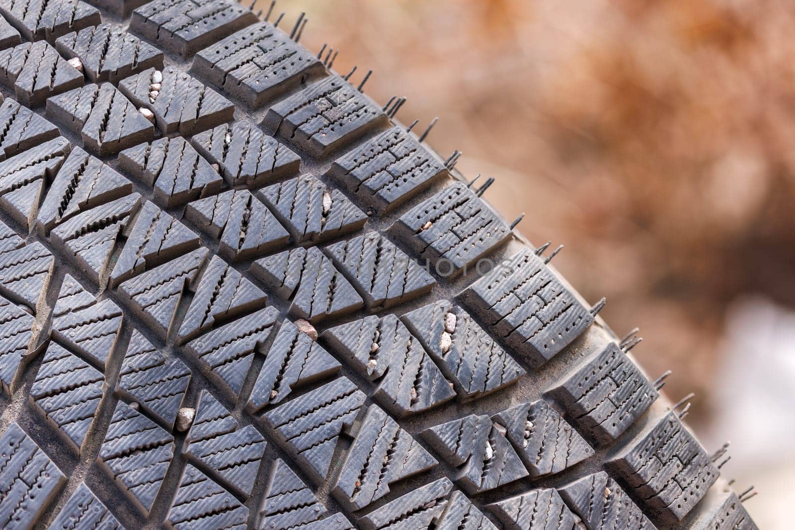 small rocks stuck in car tire tread, closeup by z1b