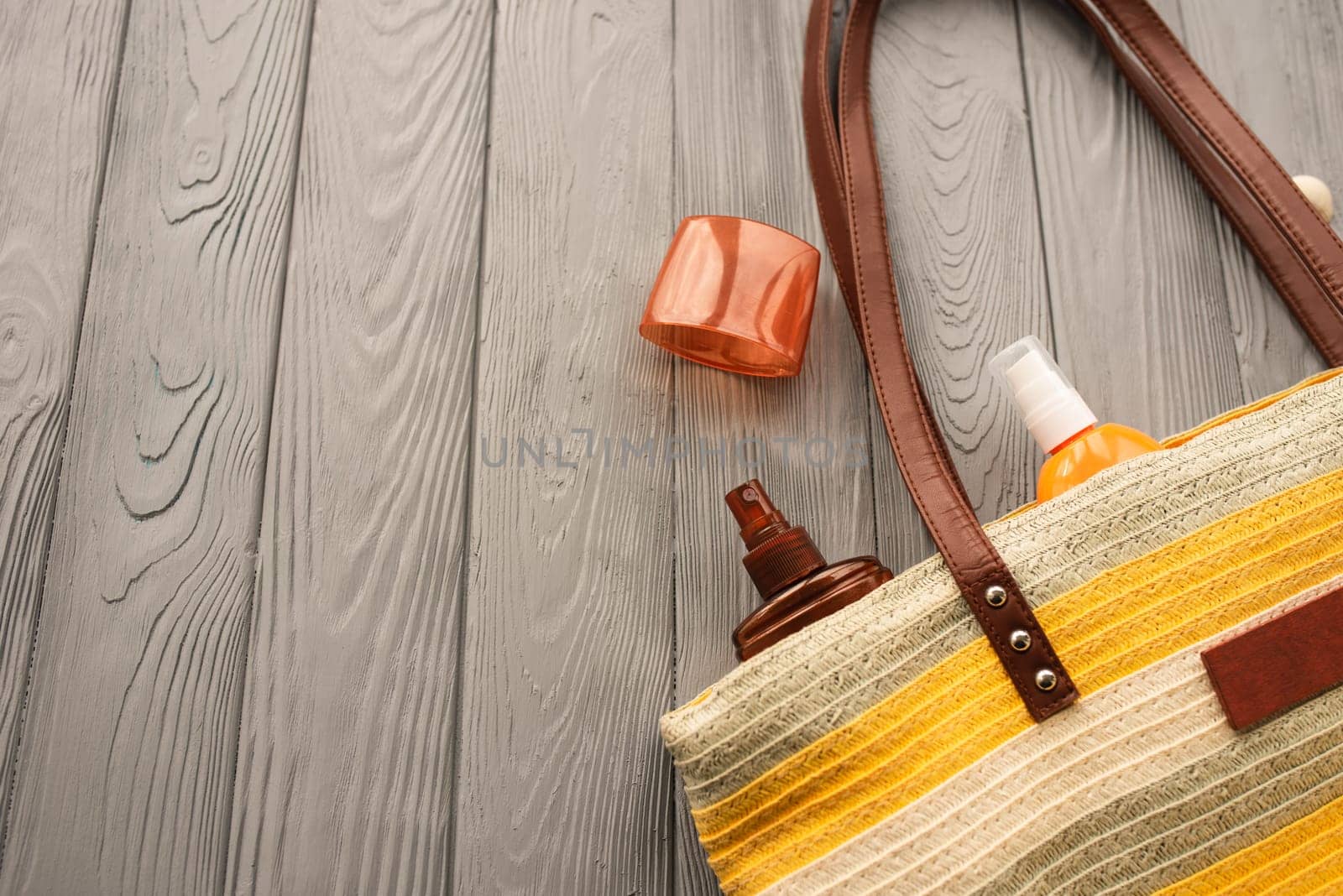 beachwear bag sun protection sunglasses sunscreen spray lotion cream care tan ultra-violet rays. Summer background template mockup free space pattern composition text. Top view above wooden background