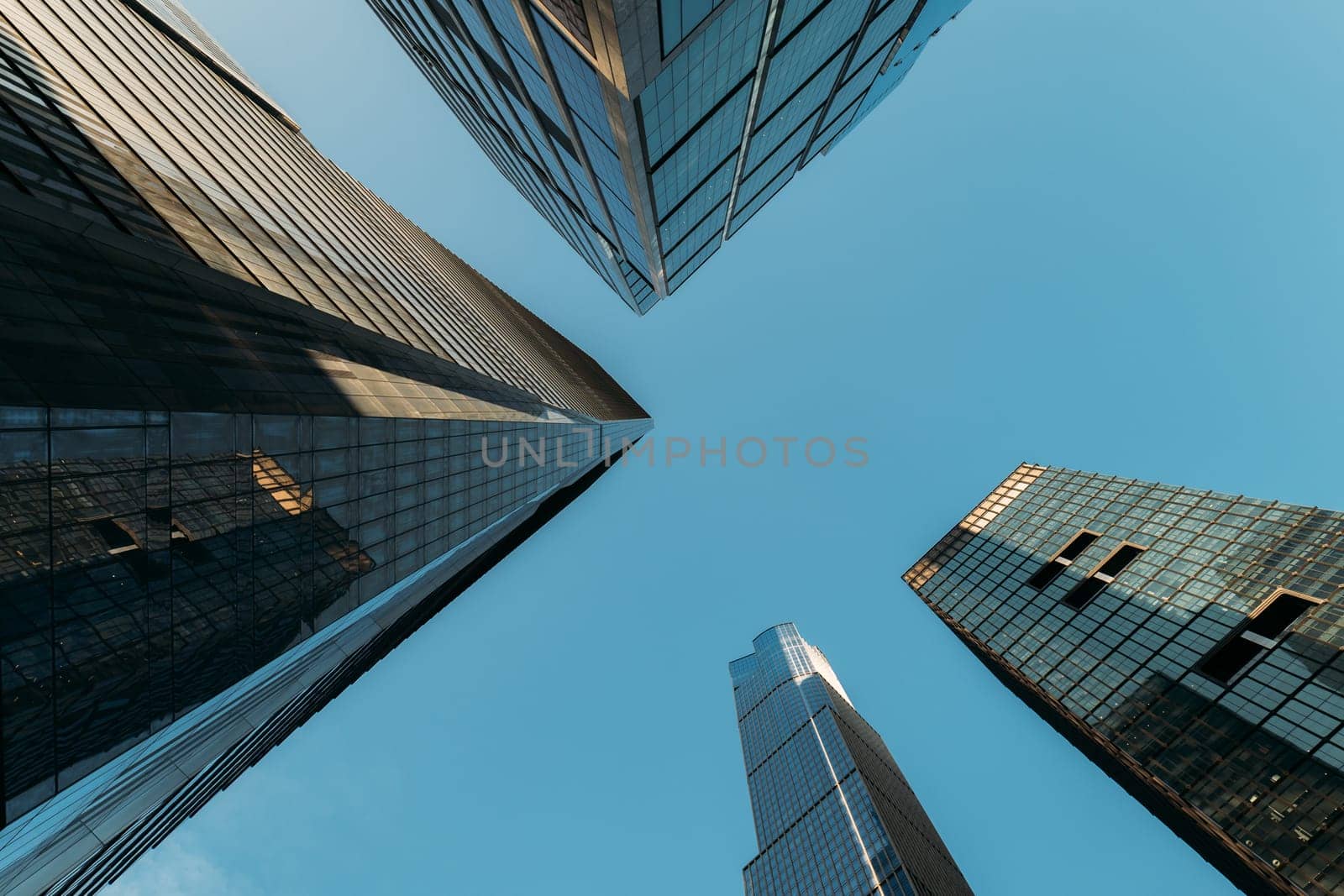 Looking Up at Skyscrapers in New York City with Clear Blue Skies by apavlin