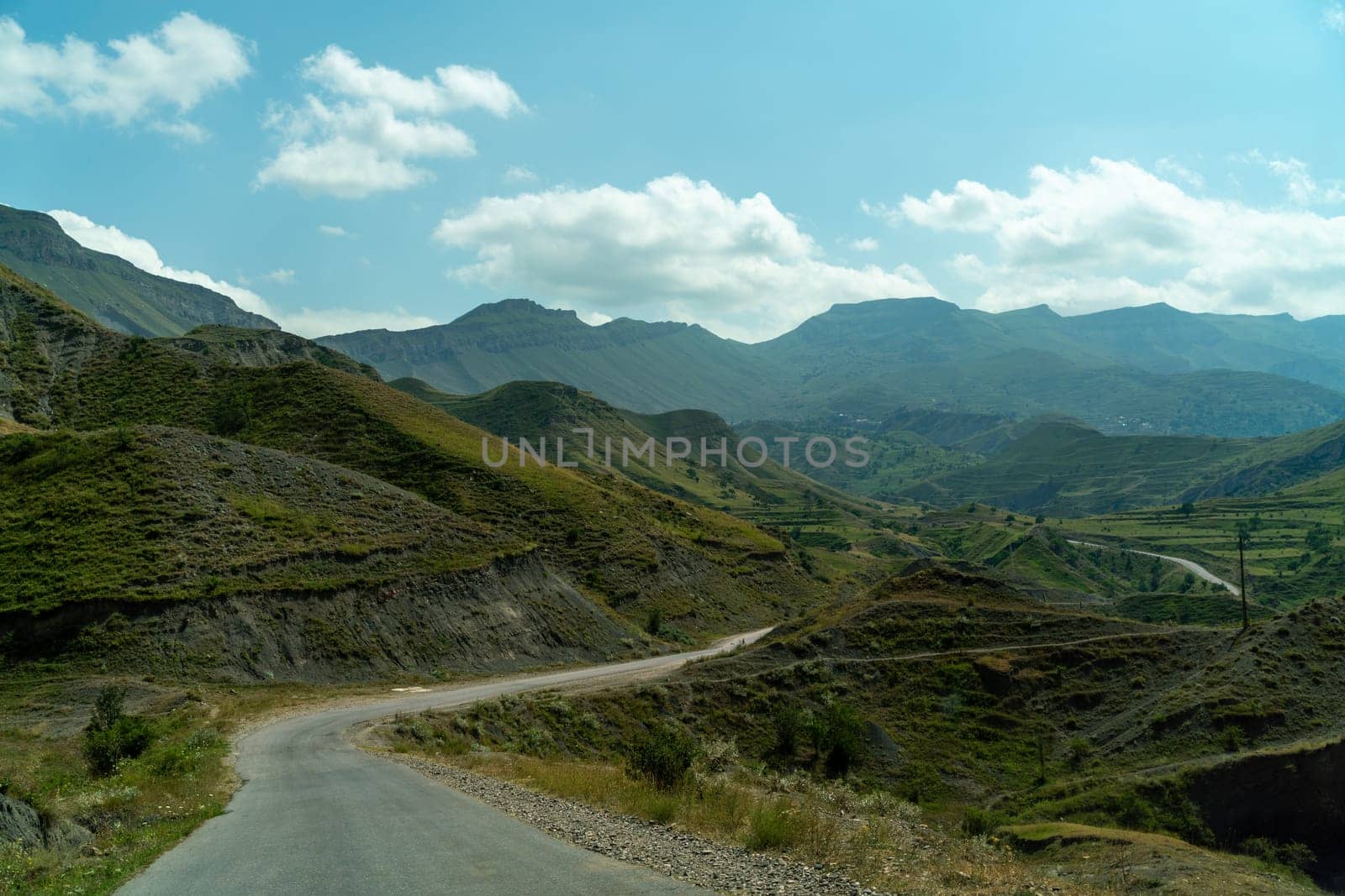 View from the car of an asphalt road in the mountainous area of Dagestan by Matiunina