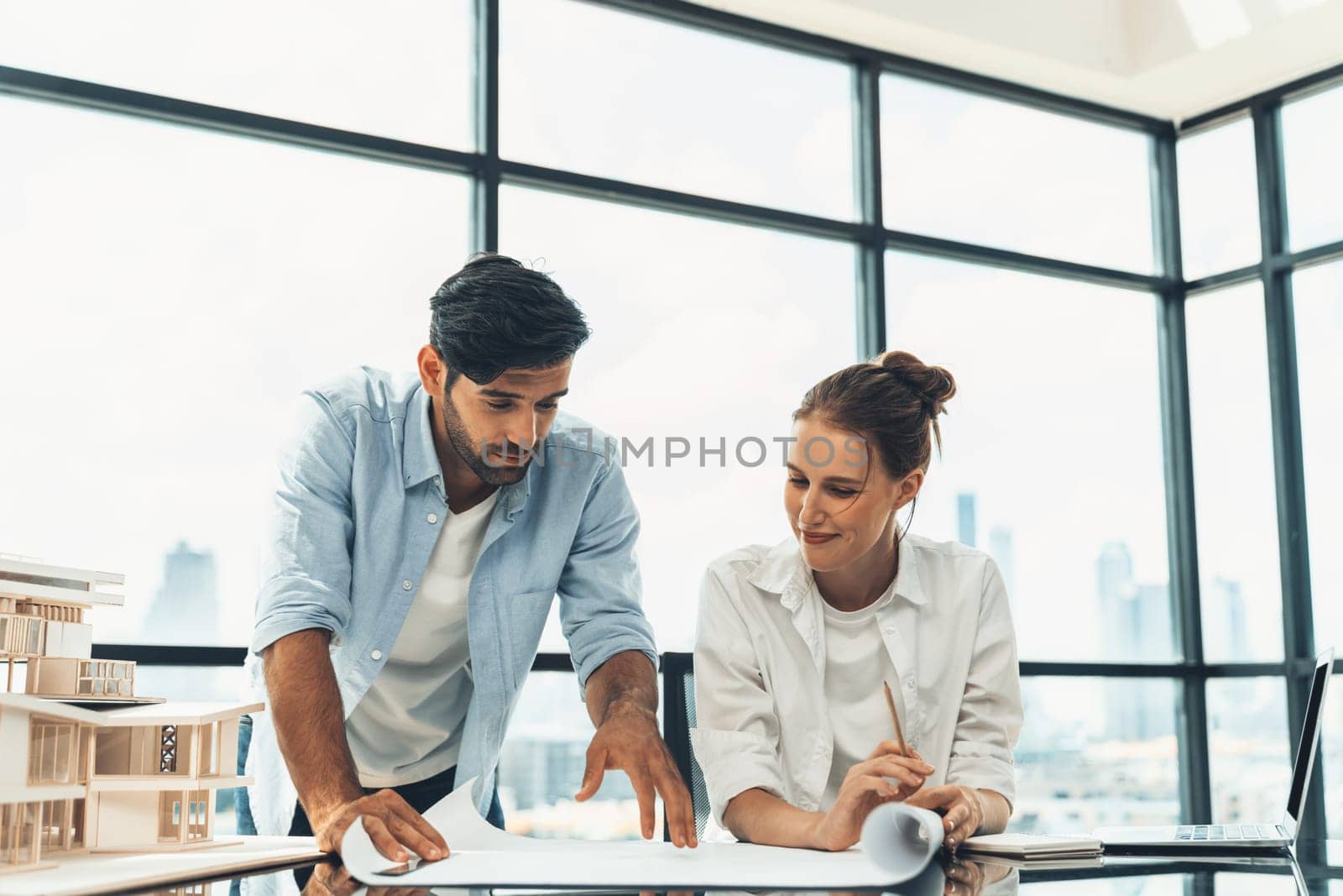 Professional diverse architect engineer team working together to design house model. Group of successful business team discussing and brainstorming about house structure. Civil engineering. Tracery.