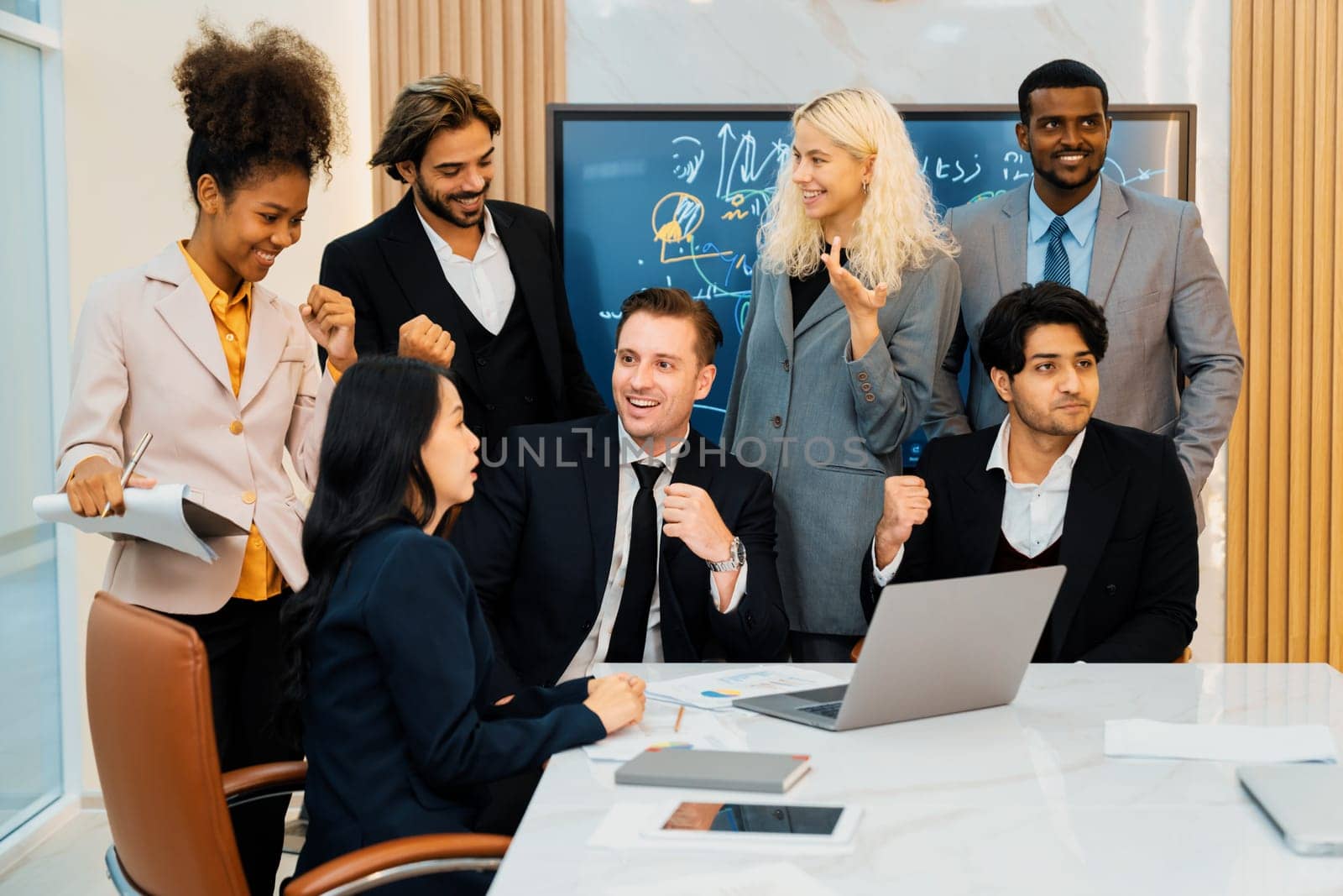 Multicultural businesspeople brainstorming business idea together. Diverse professional business team working together, sharing, planing idea, strategy. Meeting room, laptop, presentation. Ornamented.
