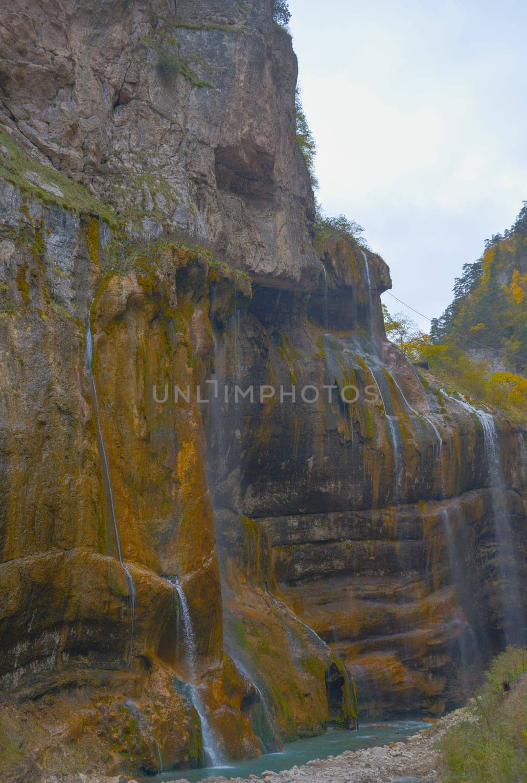 Scenic view of trees and river in the mountains in autumn.