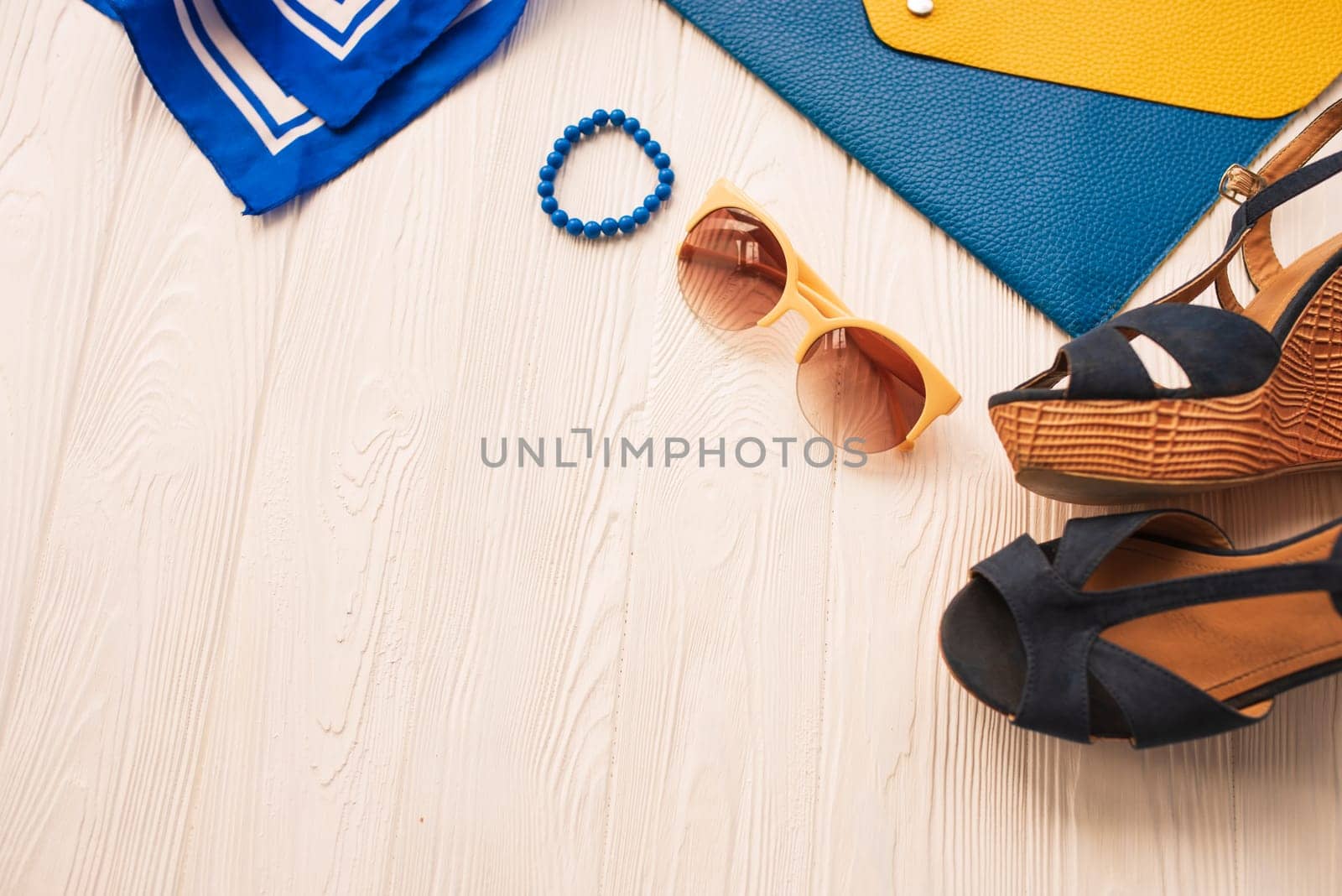 Sunglasses bijouterie jewelry bracelets clutch bag wedges shoes. Summer background mockup. top view above white wooden background Summer fashion accessories beach. Women summer design Vacation concept