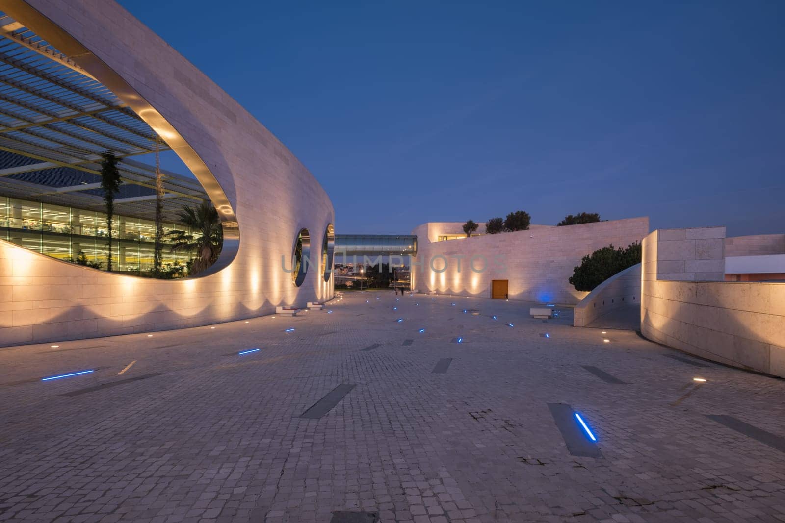 Lisbon, Portugal - January 13, 2023: Modern architecture of the Champalimaud foundation building - Portuguese non-profit foundation for scientific medical research in Belem illuminated in night time