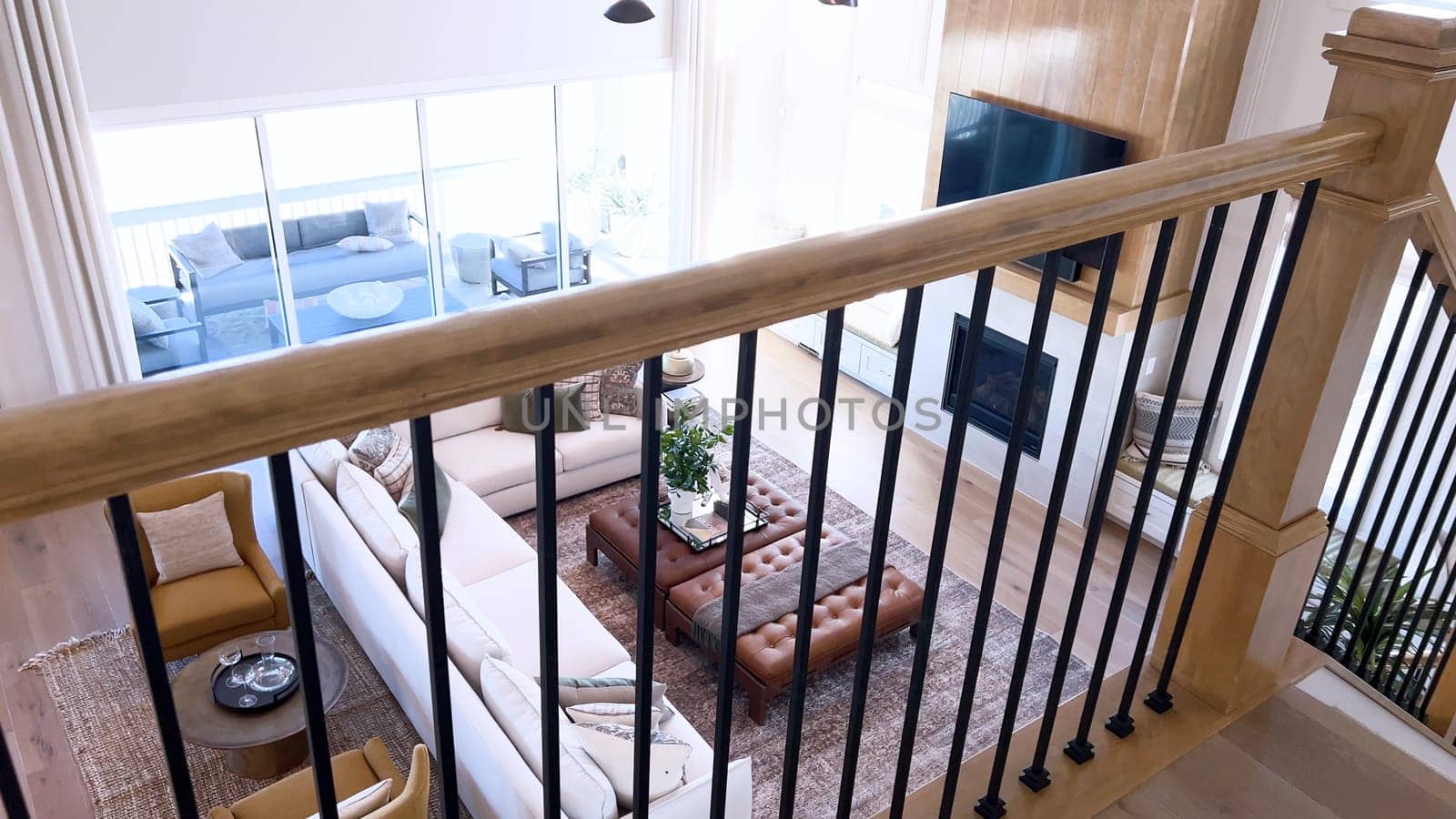 The image captures the detail of a well-designed modern staircase, lined with plush beige carpet, complemented by white walls and wooden balusters.