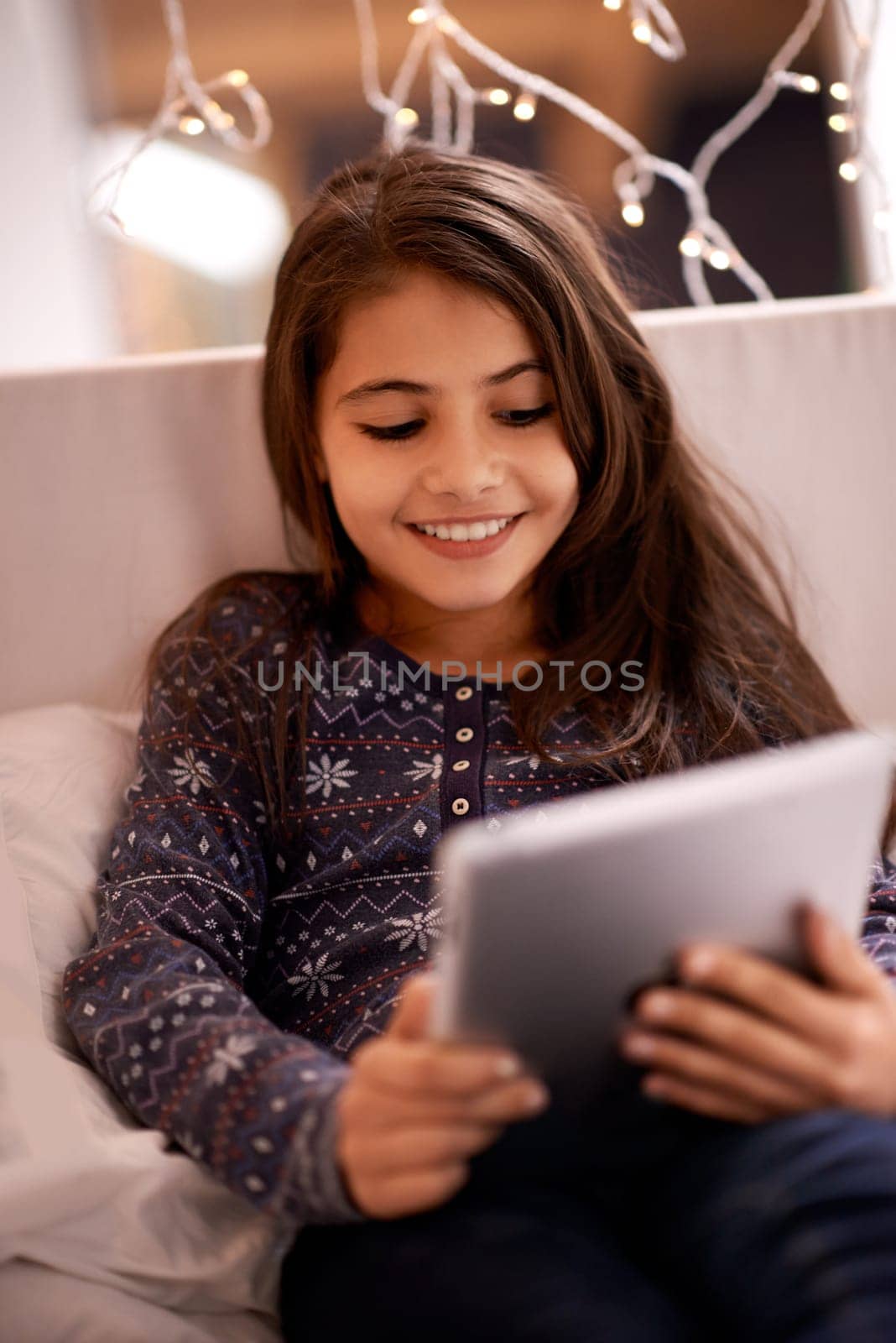 Girl, kid and tablet, technology and communication with ebook for reading and social media at home. Elearning, movie or storytelling app with internet, browsing and digital platform for gaming.