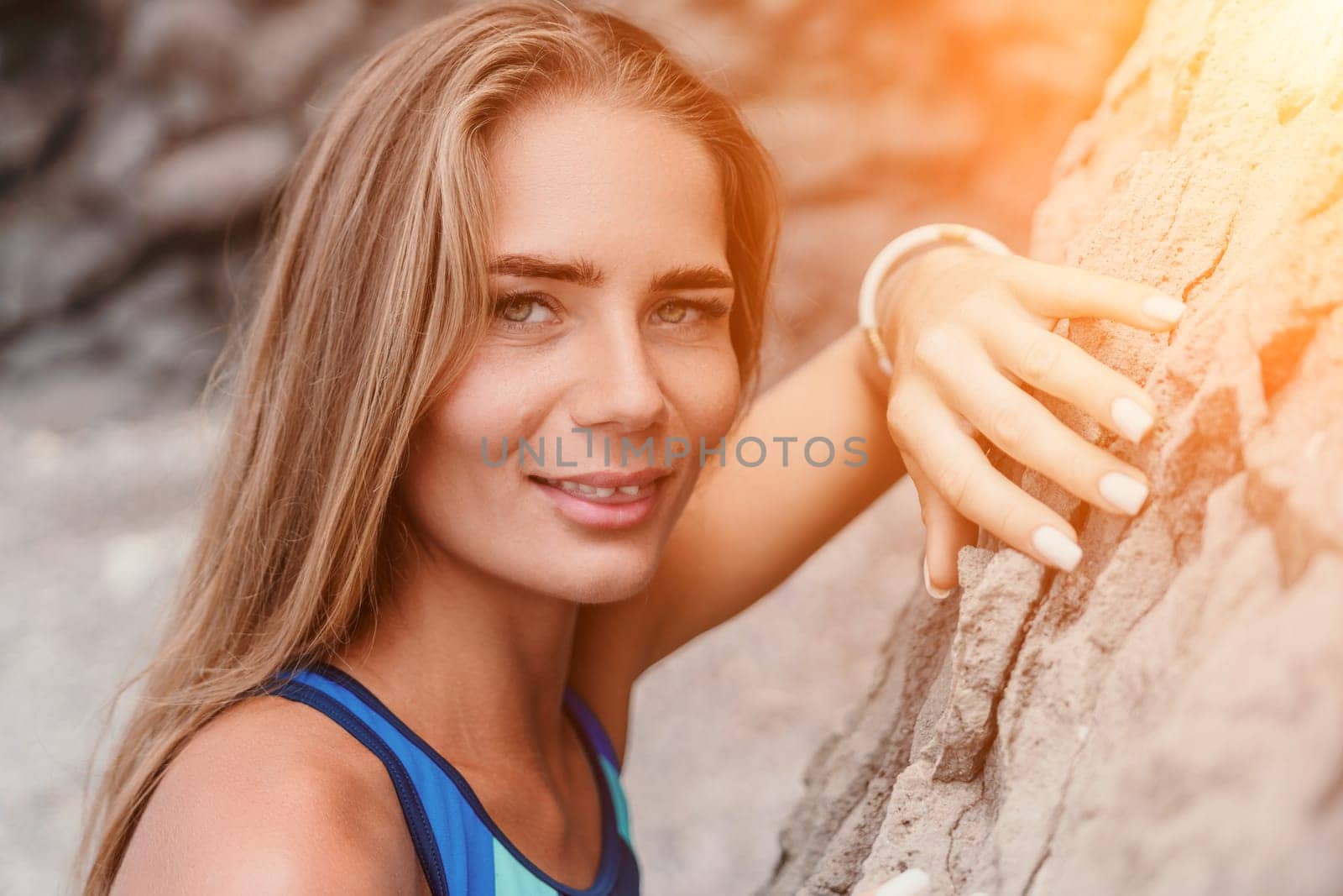 Woman summer travel sea. Happy tourist in blue bikini enjoy taking picture outdoors for memories. Woman traveler posing on the beach surrounded by volcanic mountains, sharing travel adventure journey by panophotograph