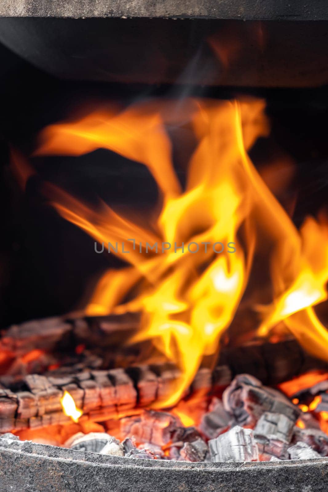 Burning coals in a metal grill for frying meat and vegetables. by AnatoliiFoto