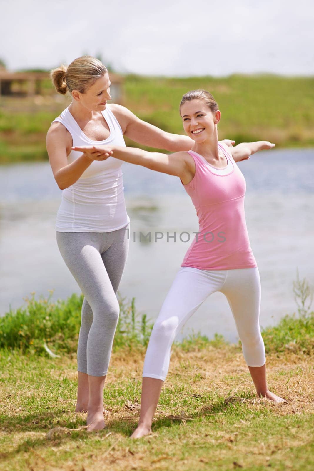 Women, yoga class and help with exercise outdoor for health, wellness and healing with coach. Fitness, pilates and stretching muscle for workout in park or garden, personal trainer and balance.