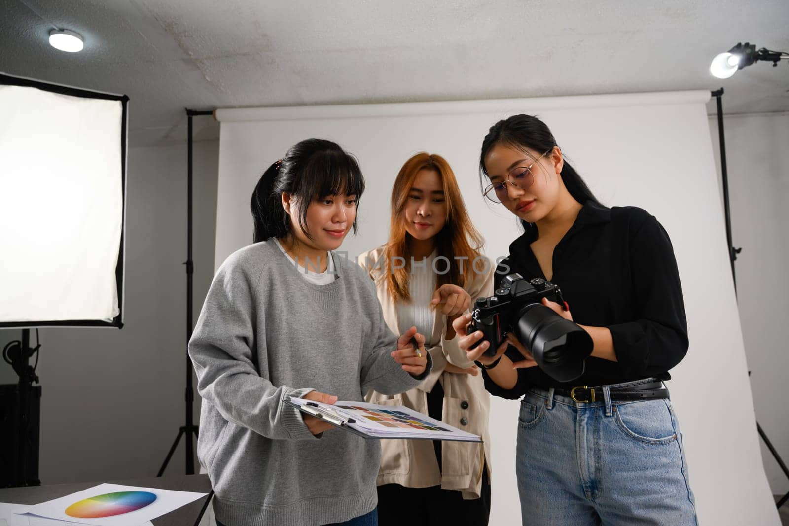 Photographer and production team working together in a professional studio.