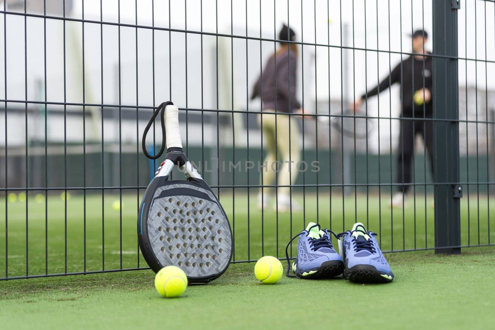 Padel tennis racket sport court and balls. Download a high quality photo with paddle for the design of a sports app or soical media advertisement. High quality photo