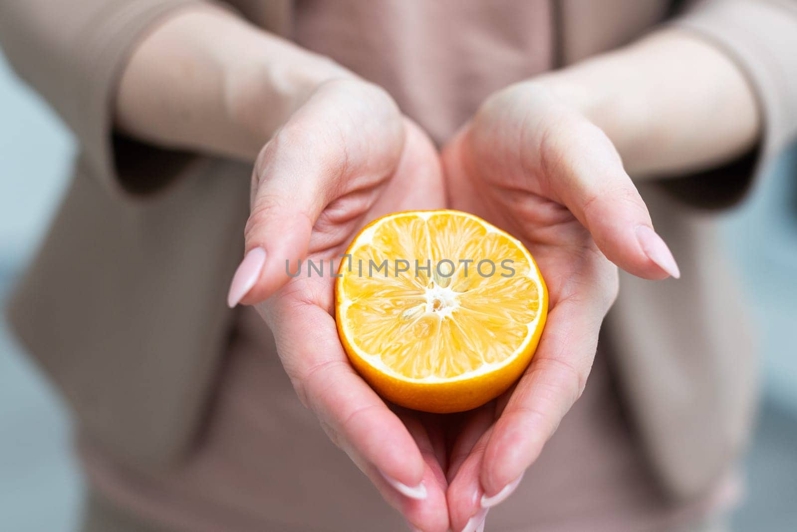 A female hand holding an orange slice, over white background with using path. High quality photo