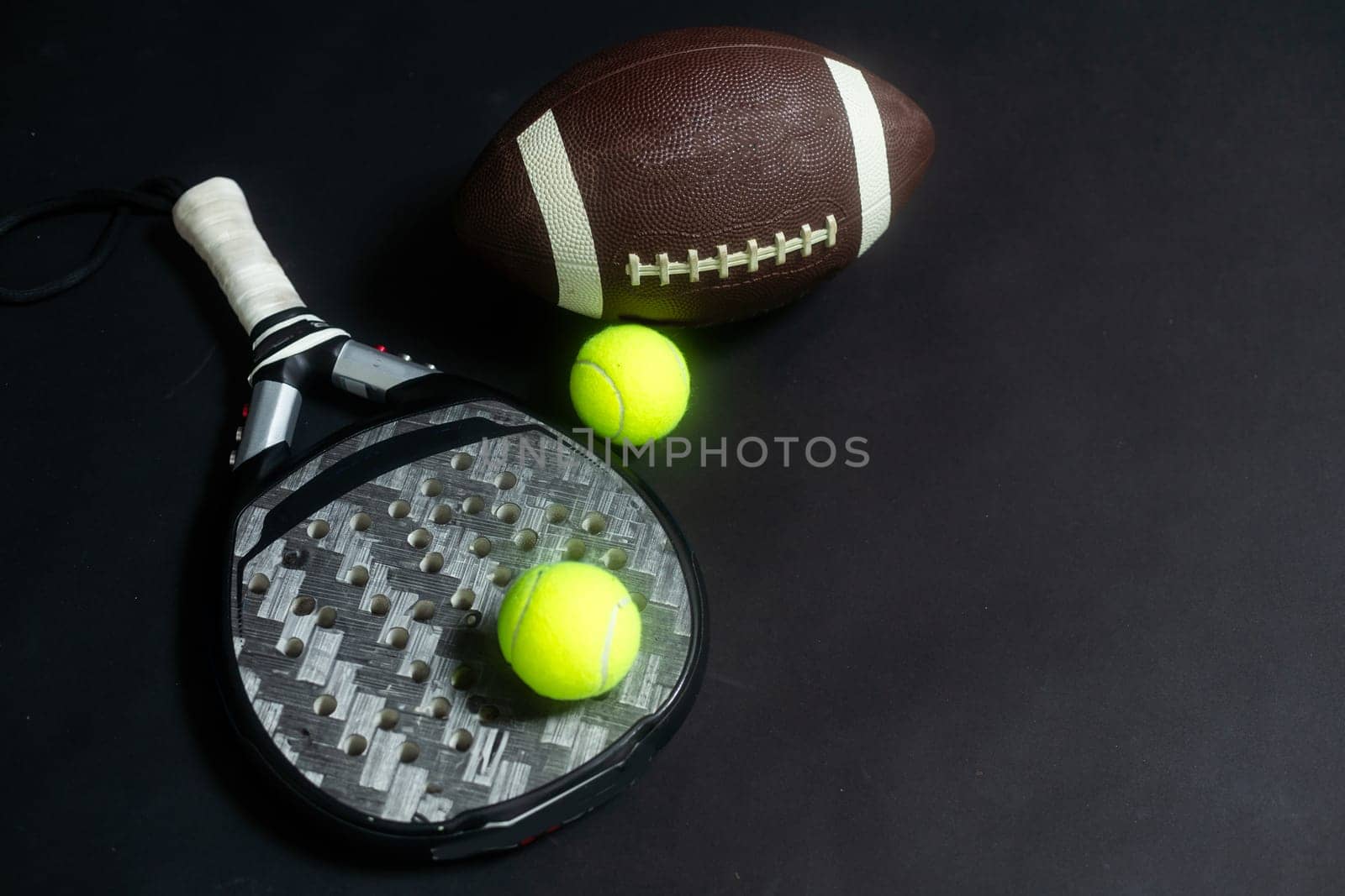 Sports equipment, rackets and balls on black background. Horizontal education and sport poster, greeting cards, headers, website. High quality photo