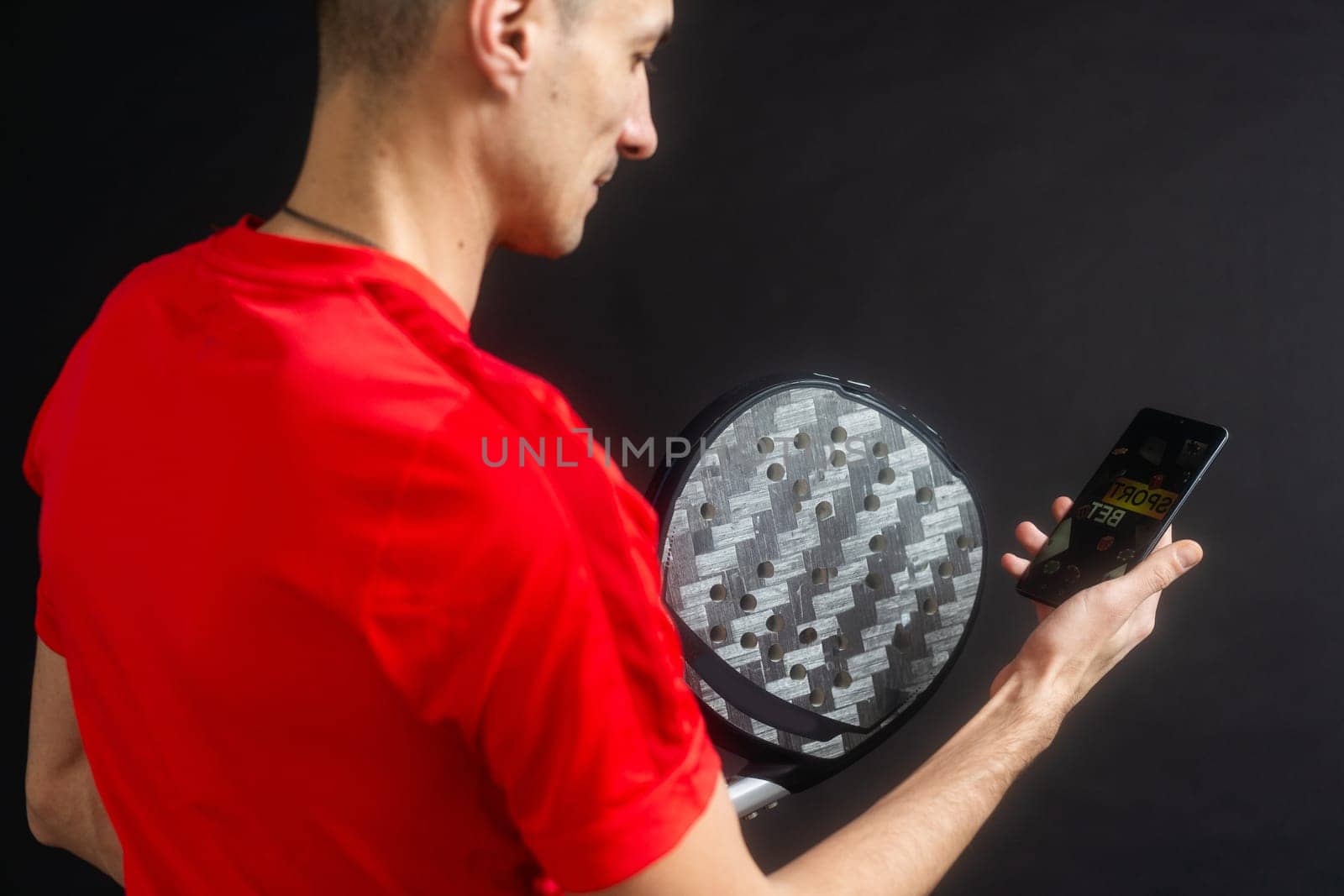 man holding paddel racket and smartphone. High quality photo