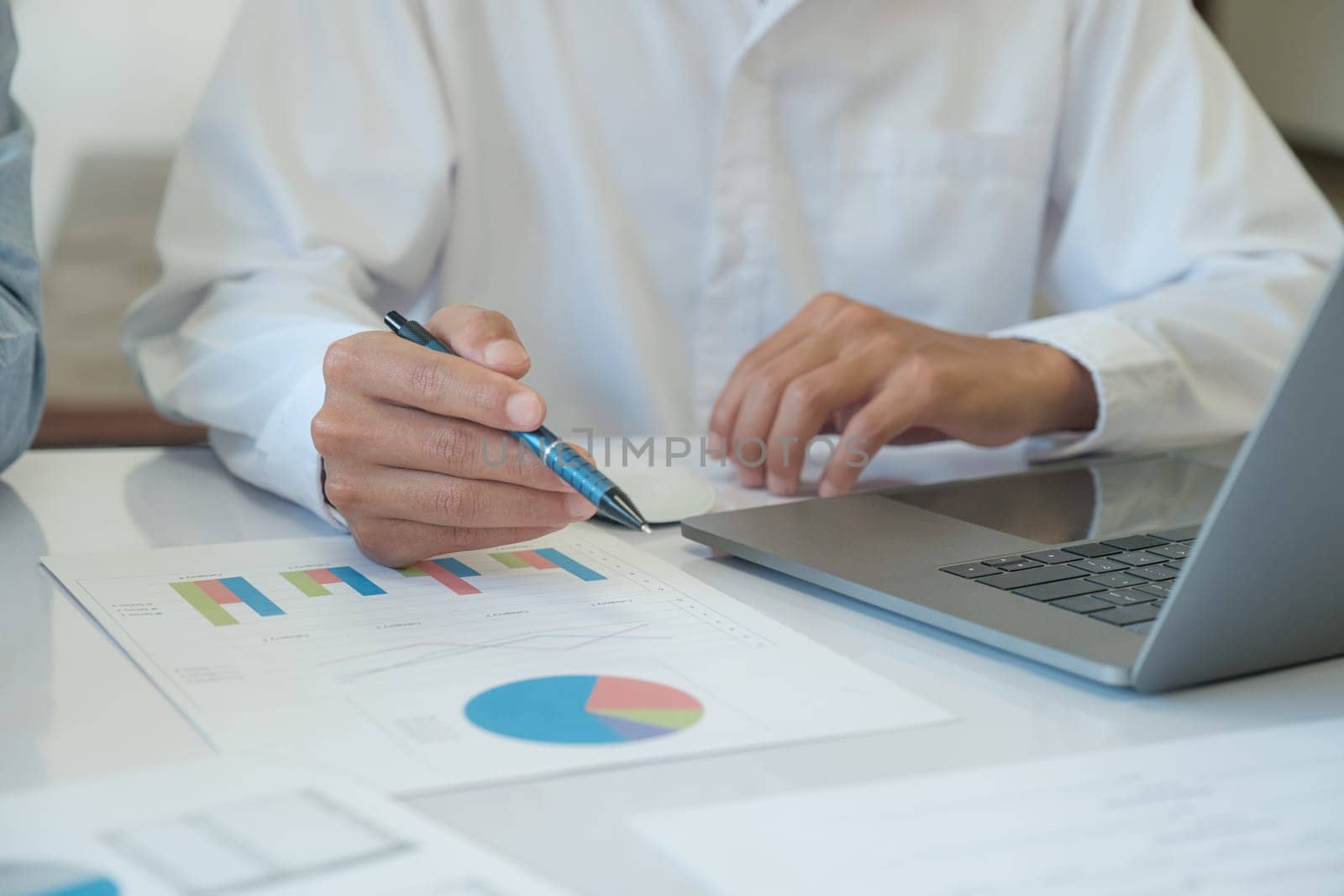 Businessman is analyzing market data and investing from the graph