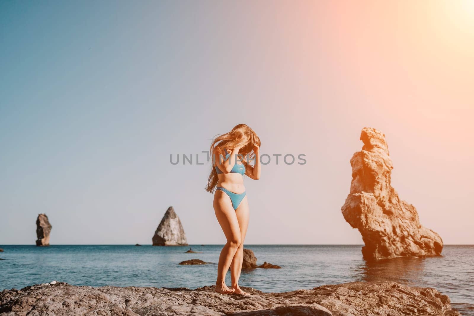 Woman sea pilates. Sporty happy middle aged woman practicing fitness on beach near sea, smiling active female training on yoga mat outside, enjoying healthy lifestyle, harmony and meditation. by panophotograph